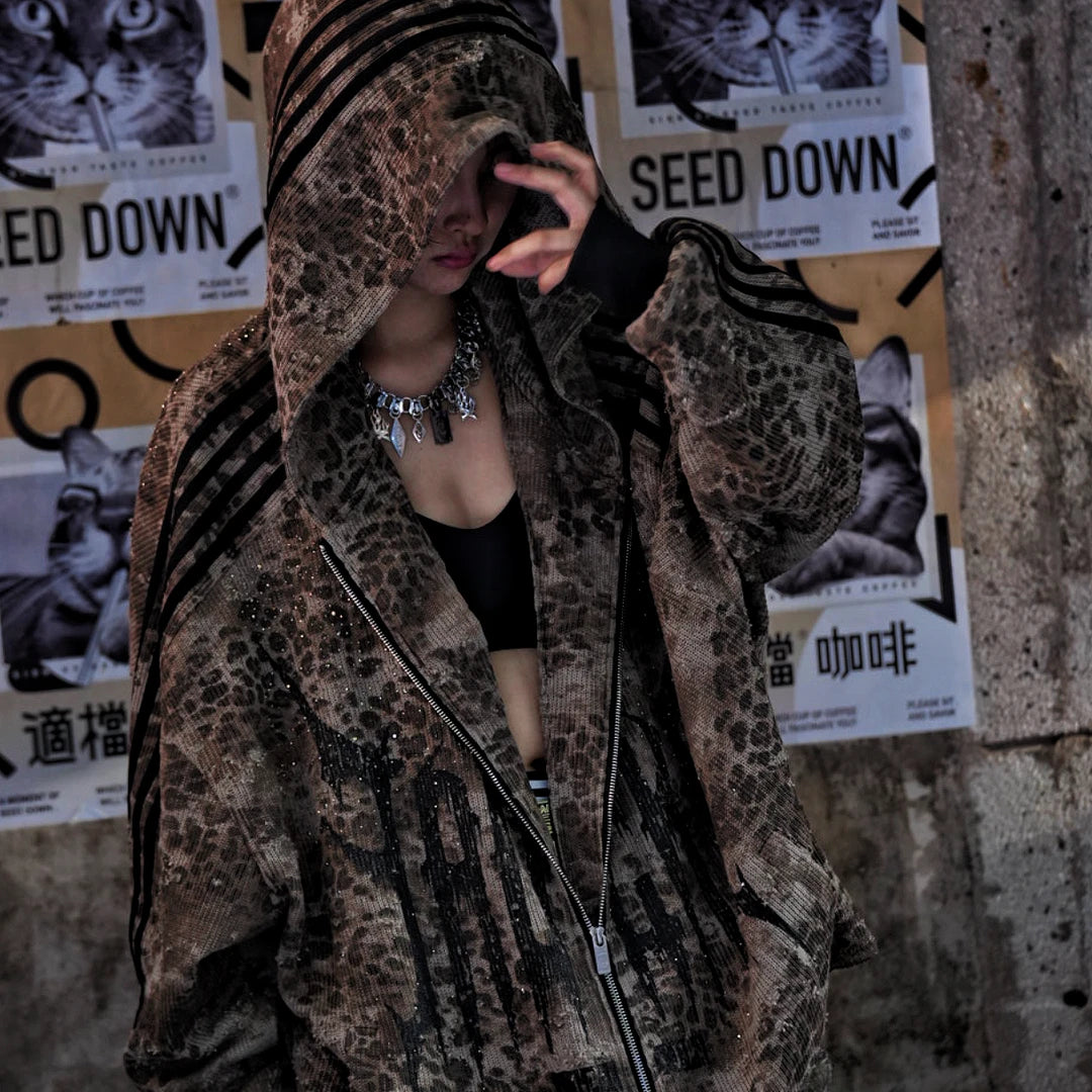 Sanhoostudio long sleeve cardigan featuring patchwork construction, graphic print details, and rhinestone embellishments with a relaxed oversized silhouette. Designed for early fall streetwear styling with bold visual texture, comfortable layering, and standout urban appeal.