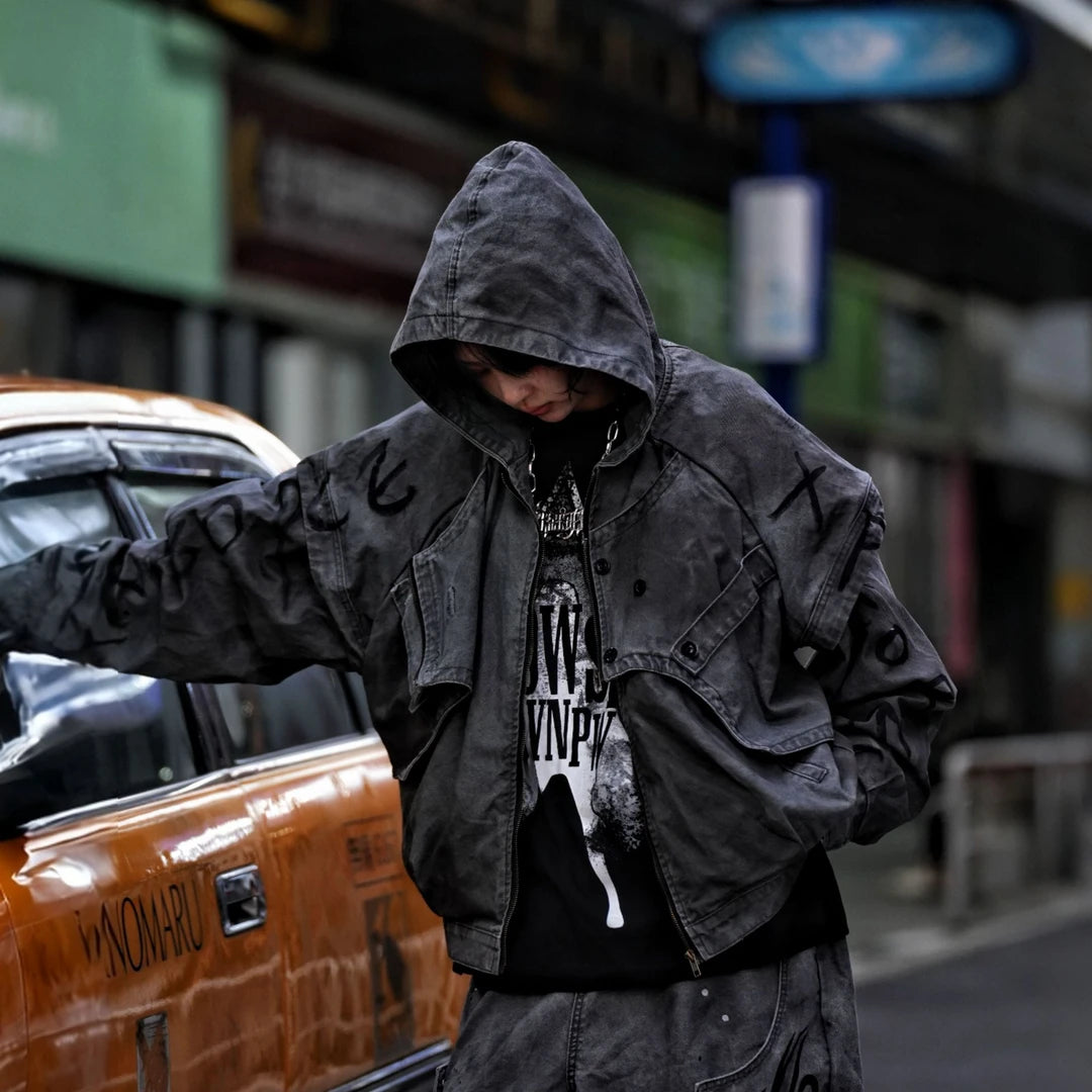 Sanhoostudio denim jacket featuring grey and black tones, hand-painted graffiti artwork, distressed staining, mud-dye treatment, and a relaxed oversized silhouette. Designed for statement streetwear layering with rich visual texture, vintage character, and bold urban appeal.