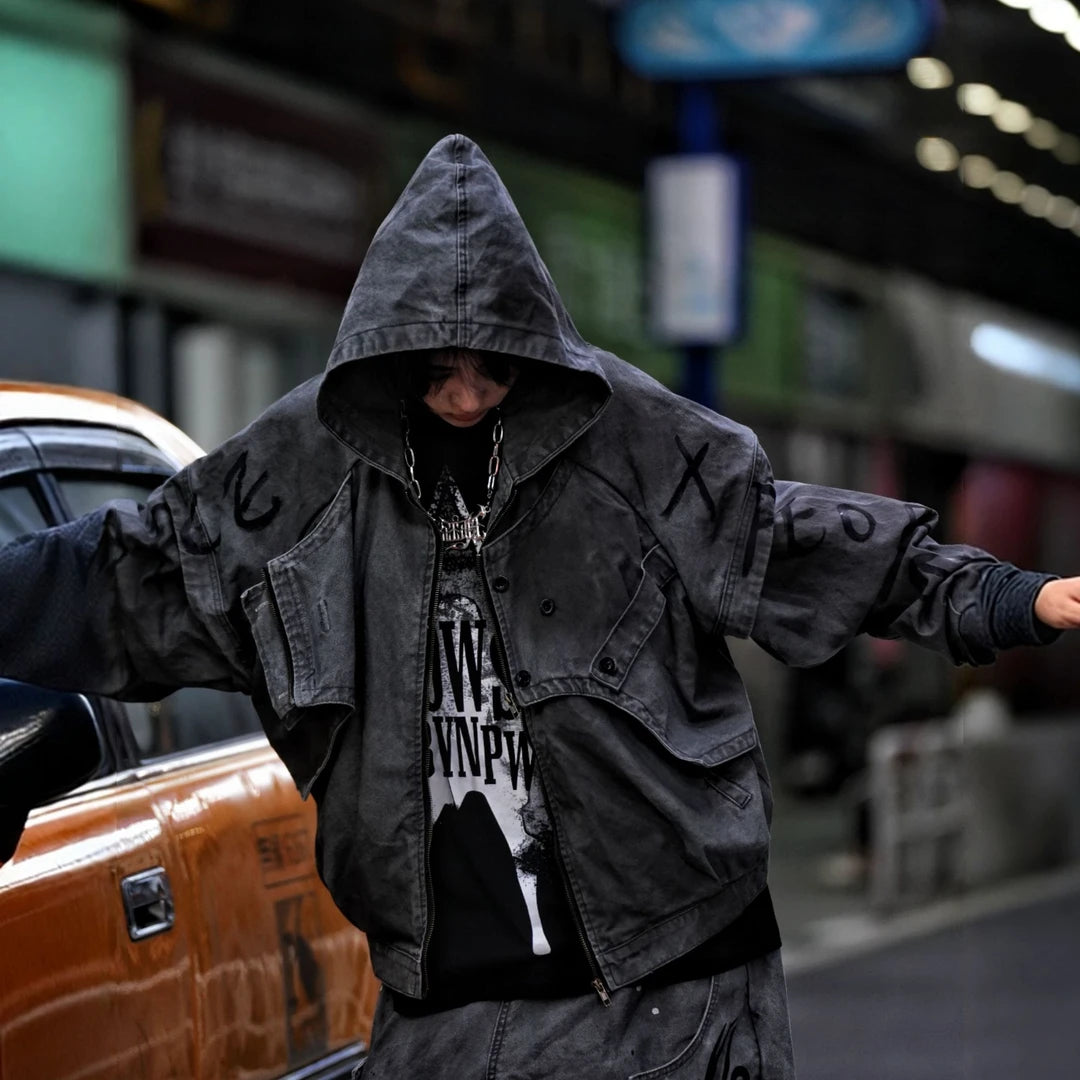 Sanhoostudio denim jacket featuring grey and black tones, hand-painted graffiti artwork, distressed staining, mud-dye treatment, and a relaxed oversized silhouette. Designed for statement streetwear layering with rich visual texture, vintage character, and bold urban appeal.