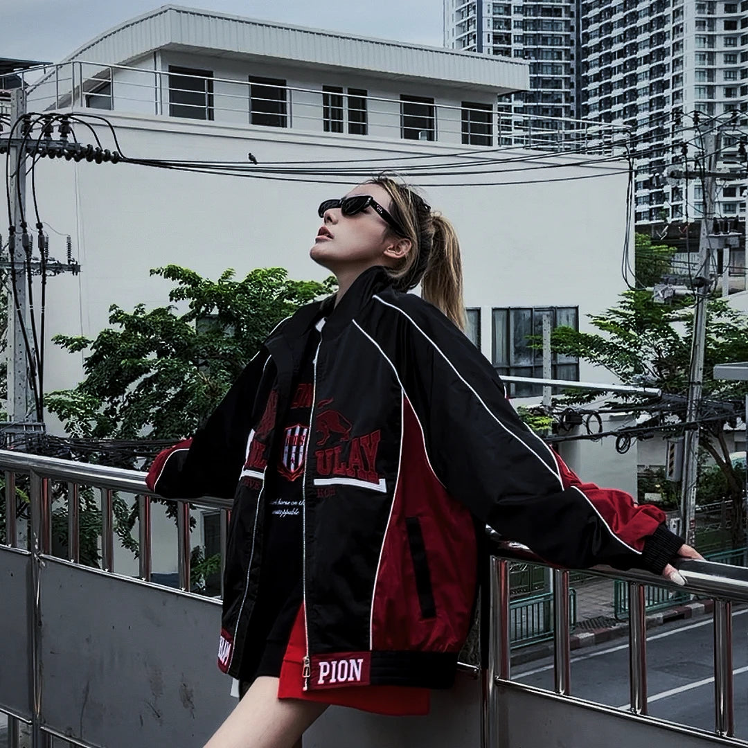 Sanhoostudio moto jacket featuring contrast colorblock panels, embroidered letter detailing, a structured stand collar, and a relaxed silhouette. Designed to combine vintage motorcycle influence with contemporary streetwear styling for bold and versatile everyday outfits.