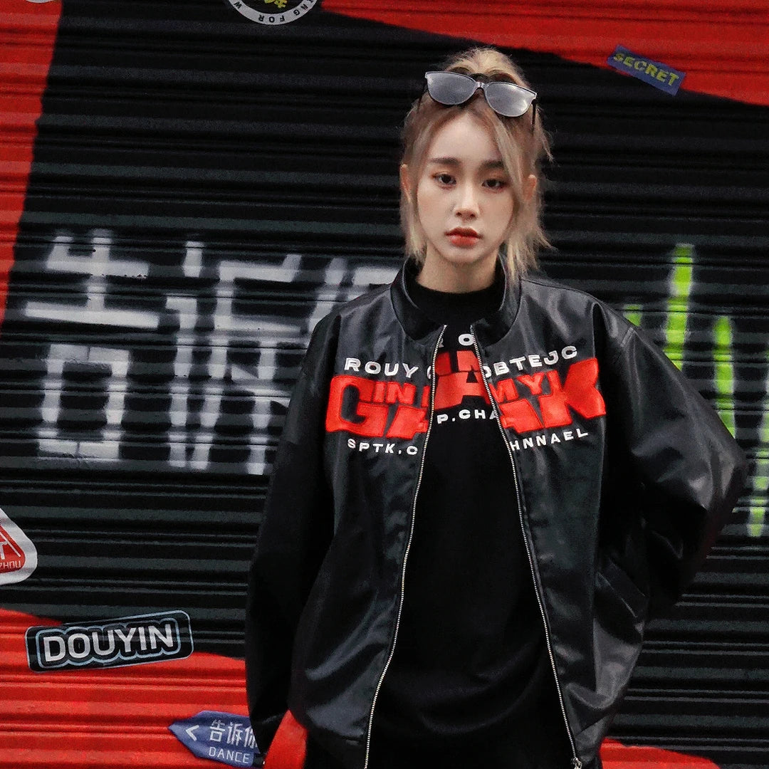 Sanhoostudio PU leather jacket featuring embroidered letter detailing, a structured shoulder silhouette, and vintage motorcycle-inspired styling. Designed for bold streetwear layering with a sleek leather look, versatile fit, and distinctive urban character.