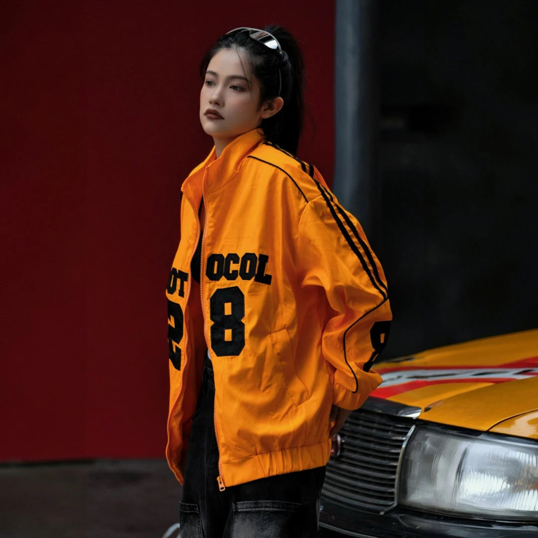 Sanhoostudio jacket featuring vintage-inspired contrast stripes, colorblock construction, a stand collar, and a zip-up front with a relaxed oversized fit. Designed for high-street layering with retro character, everyday comfort, and bold urban styling.