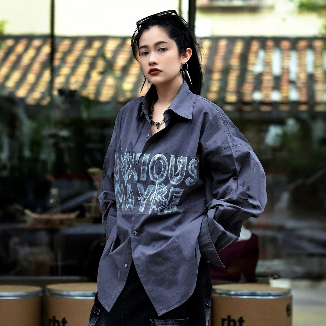 Sanhoostudio long sleeve shirt featuring metallic-effect letter detailing, relaxed dropped shoulders, and an oversized silhouette. Designed for dark high-street styling with bold visual texture, comfortable layering, and a sleek urban aesthetic for versatile everyday outfits.