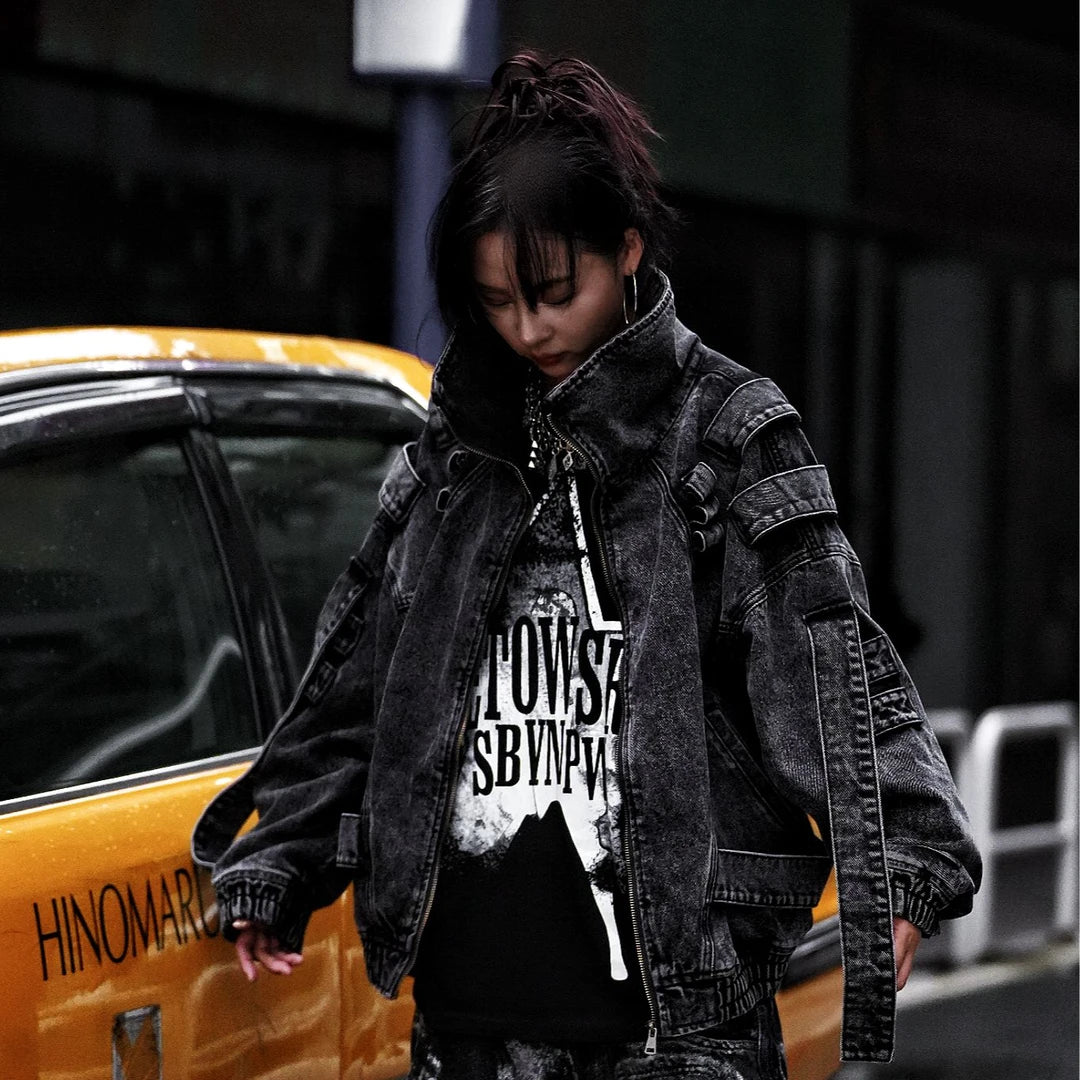 Sanhoostudio denim jacket featuring rock grey tones, hand-painted graffiti details, distressed staining, mud-dye treatment, and a relaxed oversized silhouette. Designed for statement streetwear layering with rugged visual texture, vintage-inspired character, and bold everyday urban styling.