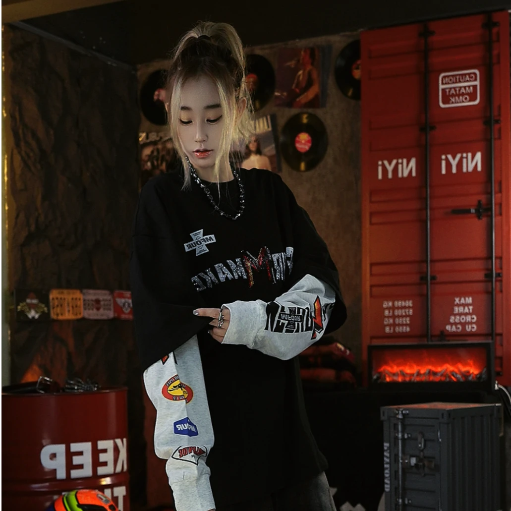 Sanhoostudio long sleeve T-shirt featuring rhinestone embellishments, contrast colorblock detailing, and a layered two-piece effect with a relaxed oversized fit. Designed for fall streetwear styling with standout texture, comfortable wear, and versatile unisex appeal.