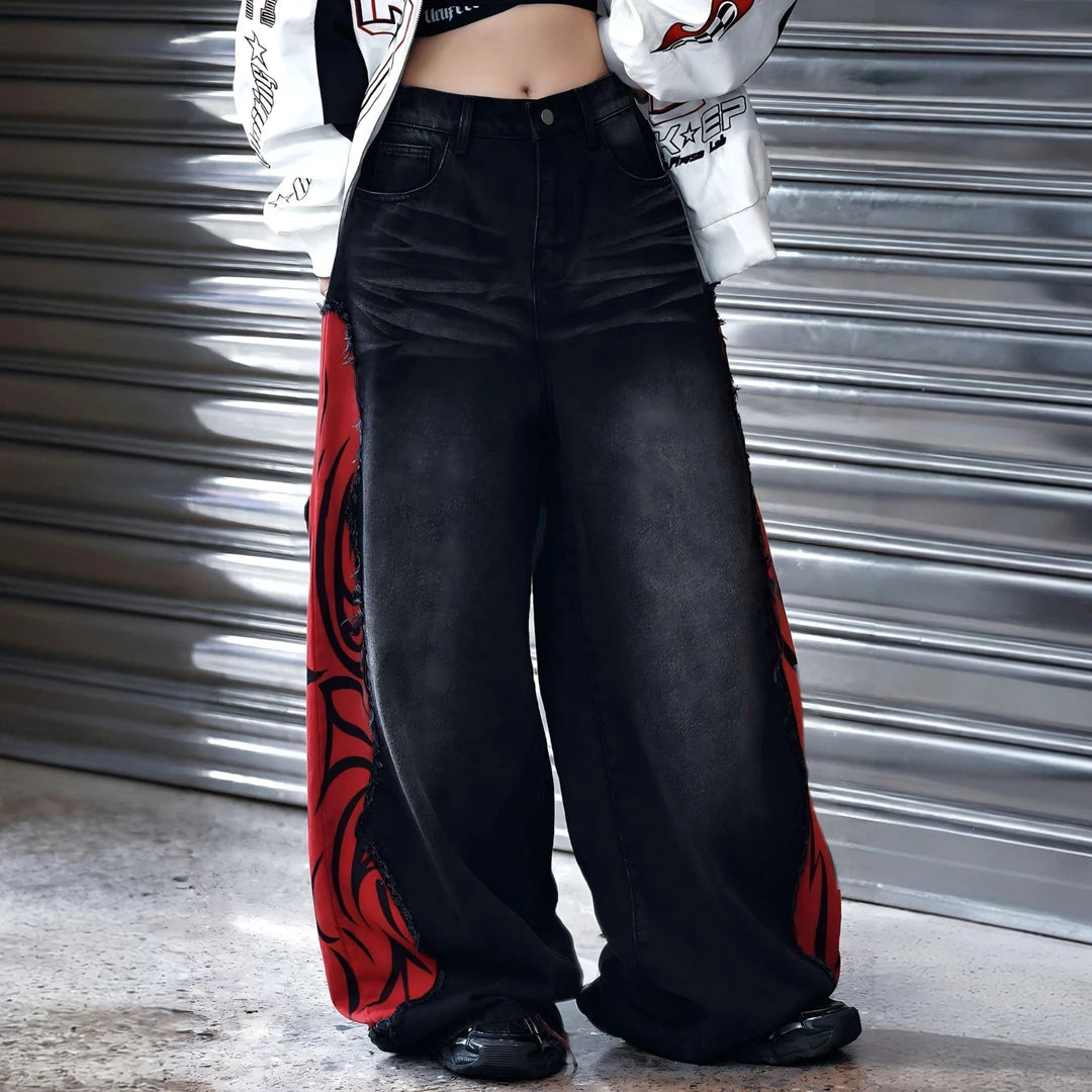 Sanhoostudio denim pants featuring flame-inspired patchwork, raw frayed detailing, and a relaxed wide leg silhouette with an extended floor-length cut. Designed for statement streetwear styling with bold contrast, vintage character, and effortless oversized proportions.