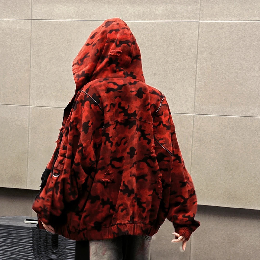 Sanhoostudio denim jacket featuring red camouflage graphics, distressed wash treatment, and a relaxed oversized silhouette. Designed for fall and winter streetwear layering with rugged vintage texture, bold visual character, and comfortable everyday styling.