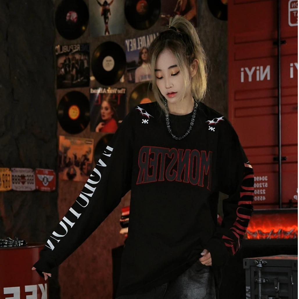 Sanhoostudio long sleeve T-shirt featuring asymmetric letter graphics and a relaxed oversized silhouette. Designed for motorcycle-inspired streetwear styling with comfortable everyday wear, distinctive graphic character, effortless layering, and a bold contemporary urban aesthetic.