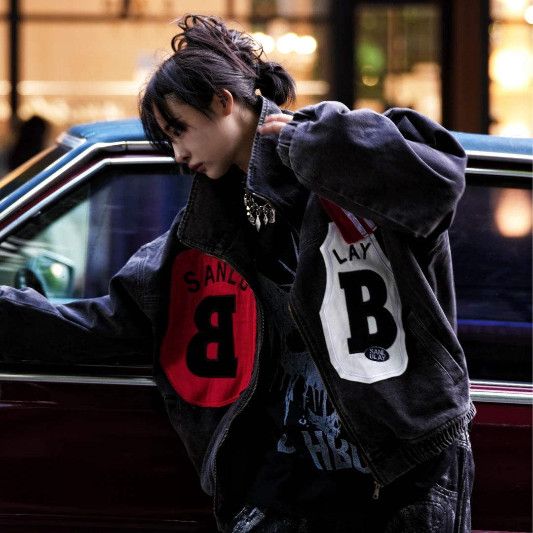 Sanhoostudio denim jacket featuring mixed patch applique embroidery, distressed stain effects, and a relaxed oversized silhouette. Designed for contemporary streetwear layering with handcrafted detailing, rugged denim texture, distinctive visual contrast, and bold everyday styling.