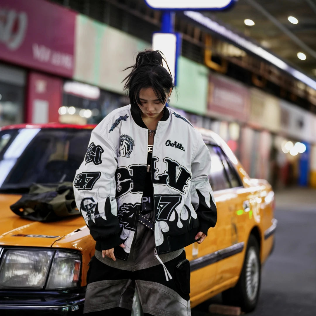 Sanhoostudio padded jacket featuring warhorse-inspired embroidery, contrast patchwork detailing, and a relaxed oversized silhouette. Designed for colder-season streetwear layering with vintage character, comfortable warmth, bold embroidered artwork, and distinctive everyday urban styling.
