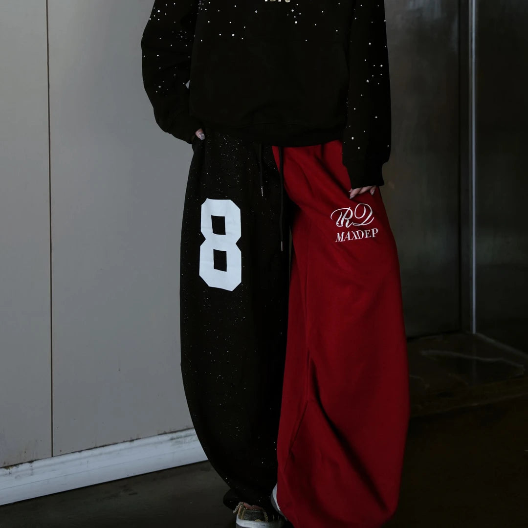 Sanhoostudio sweatpants featuring all-over rhinestone embellishments, contrast detailing, ruched texture, and a relaxed wide leg scythe silhouette. Designed for statement streetwear and dance-inspired styling with comfortable movement, bold visual texture, and distinctive urban appeal.