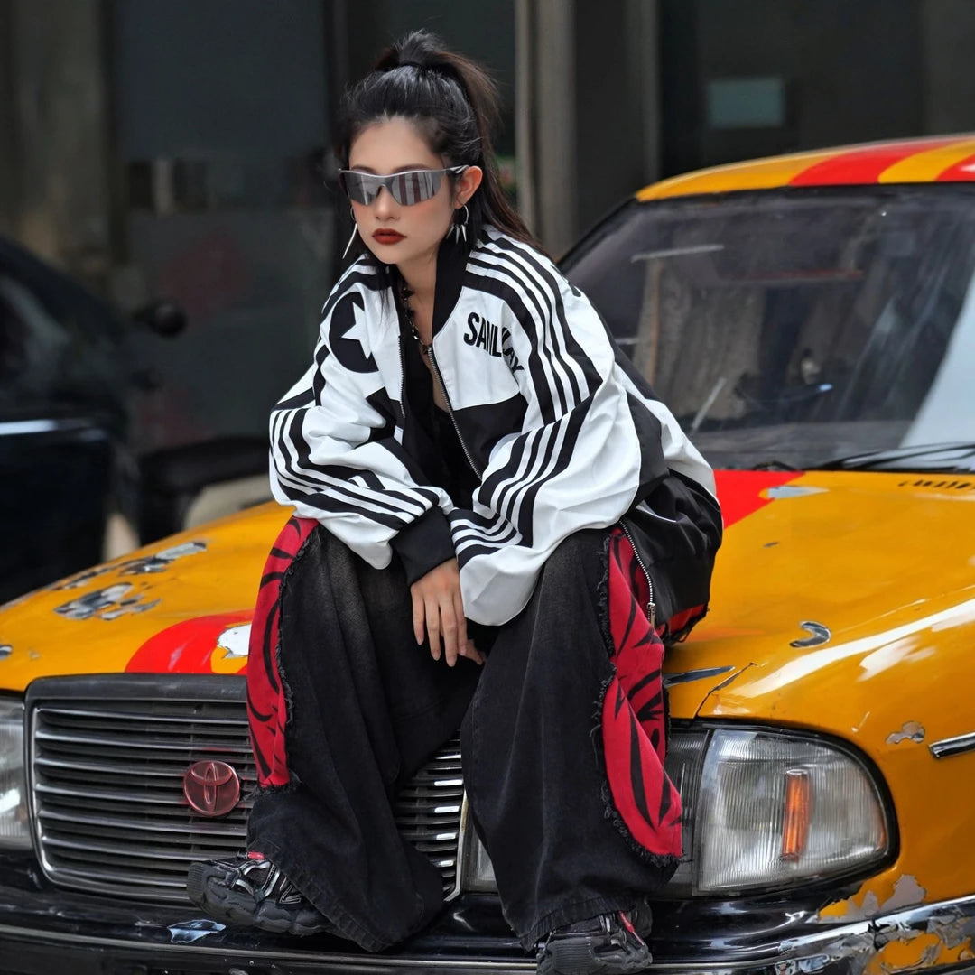 Sanhoostudio moto jacket featuring contrast colorblock panels, embroidered detailing, a structured stand collar, and a relaxed oversized silhouette. Designed with vintage motorcycle influence for bold streetwear layering, comfortable everyday wear, and distinctive urban styling.