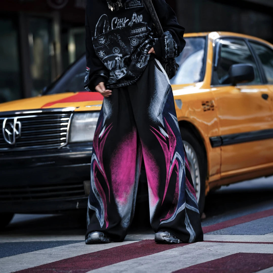 Sanhoostudio sweatpants featuring colorful washed treatment, distressed detailing, patchwork construction, and a relaxed wide leg scythe silhouette. Designed for statement streetwear styling with heavyweight texture, comfortable movement, oversized proportions, and distinctive everyday appeal.