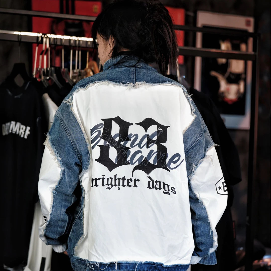 Sanhoostudio denim jacket featuring a cobalt blue colorway, digital print artwork, distressed detailing, and patchwork construction with a relaxed oversized silhouette. Designed for statement streetwear layering with bold visual texture, rugged denim character, and versatile everyday styling.