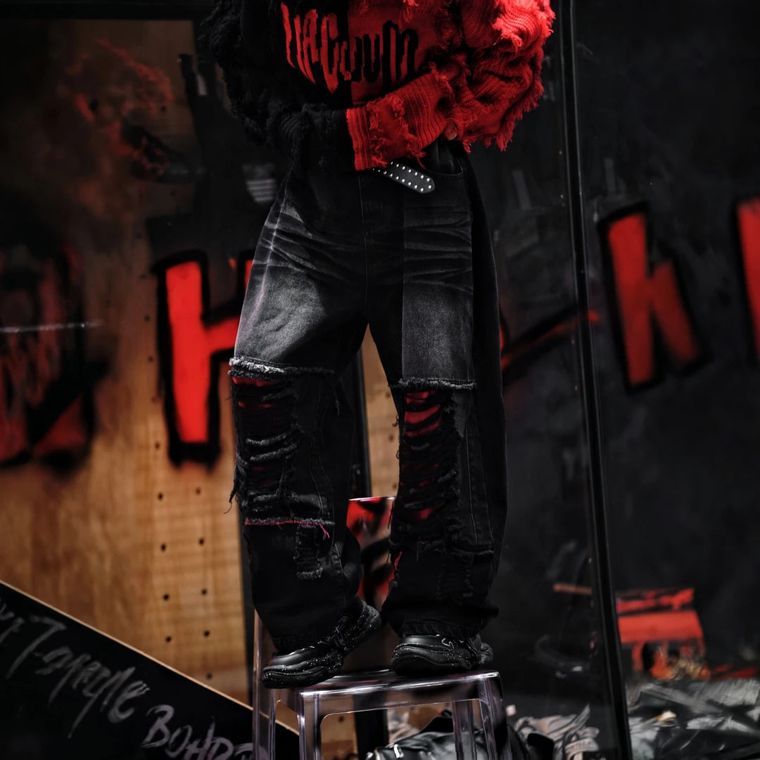 Sanhoostudio denim pants featuring a bold red colorway, heavyweight washed denim, distressed detailing, and patchwork construction with a wide leg scythe silhouette. Designed for statement streetwear styling with rugged texture, relaxed proportions, and distinctive visual appeal.