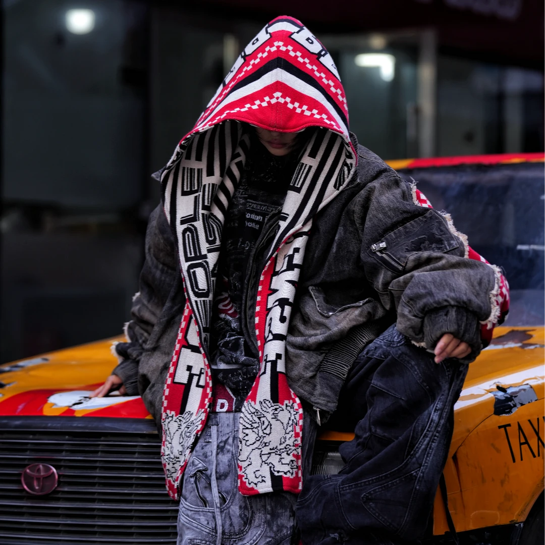 Sanhoostudio padded denim jacket featuring heavyweight washed denim, distressed graffiti artwork, hand-painted detailing, and asymmetric patchwork construction. Designed with a relaxed oversized silhouette and insulated padding for winter streetwear styling, comfortable warmth, and deconstructed visual appeal.