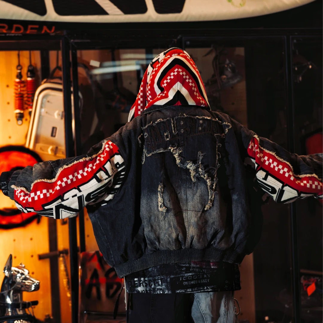 Sanhoostudio padded denim jacket featuring heavyweight washed denim, distressed graffiti artwork, hand-painted detailing, and asymmetric patchwork construction. Designed with a relaxed oversized silhouette and insulated padding for winter streetwear styling, comfortable warmth, and deconstructed visual appeal.