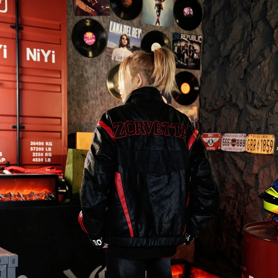 Sanhoostudio moto padded jacket featuring mesh-inspired patchwork panels, embroidered detailing, leather-look construction, and a structured stand collar. Designed for racing-inspired winter streetwear styling with comfortable insulation, bold motorsport character, and distinctive layered visual texture.