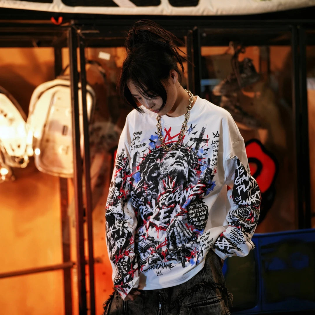 Sanhoostudio long sleeve T-shirt featuring dark Jesus-inspired graphic artwork, statement spray print detailing, and a relaxed oversized silhouette. Designed for alternative streetwear styling with soft breathable fabric, gothic visual character, comfortable everyday wear, and distinctive artistic appeal.