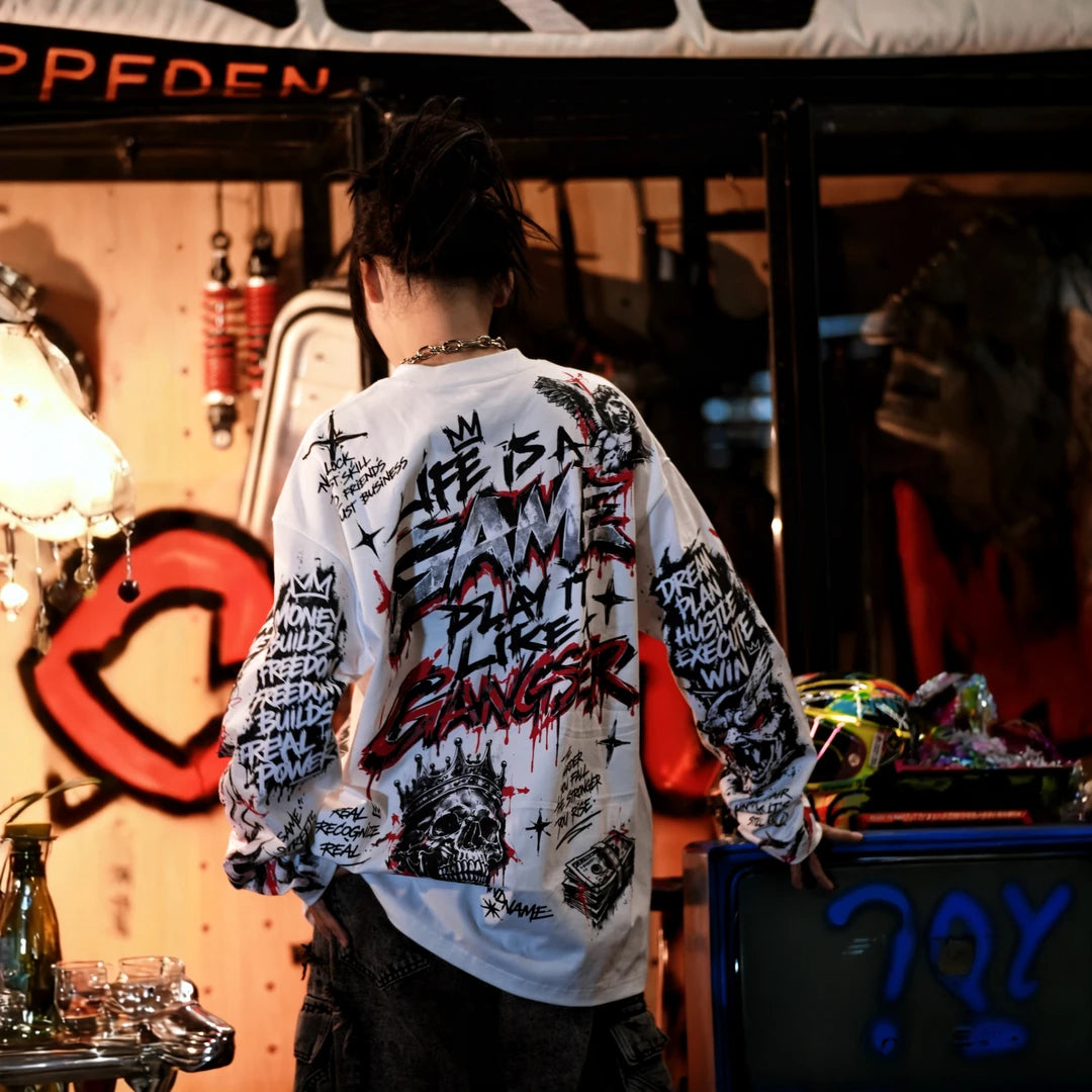 Sanhoostudio long sleeve T-shirt featuring dark Jesus-inspired graphic artwork, statement spray print detailing, and a relaxed oversized silhouette. Designed for alternative streetwear styling with soft breathable fabric, gothic visual character, comfortable everyday wear, and distinctive artistic appeal.