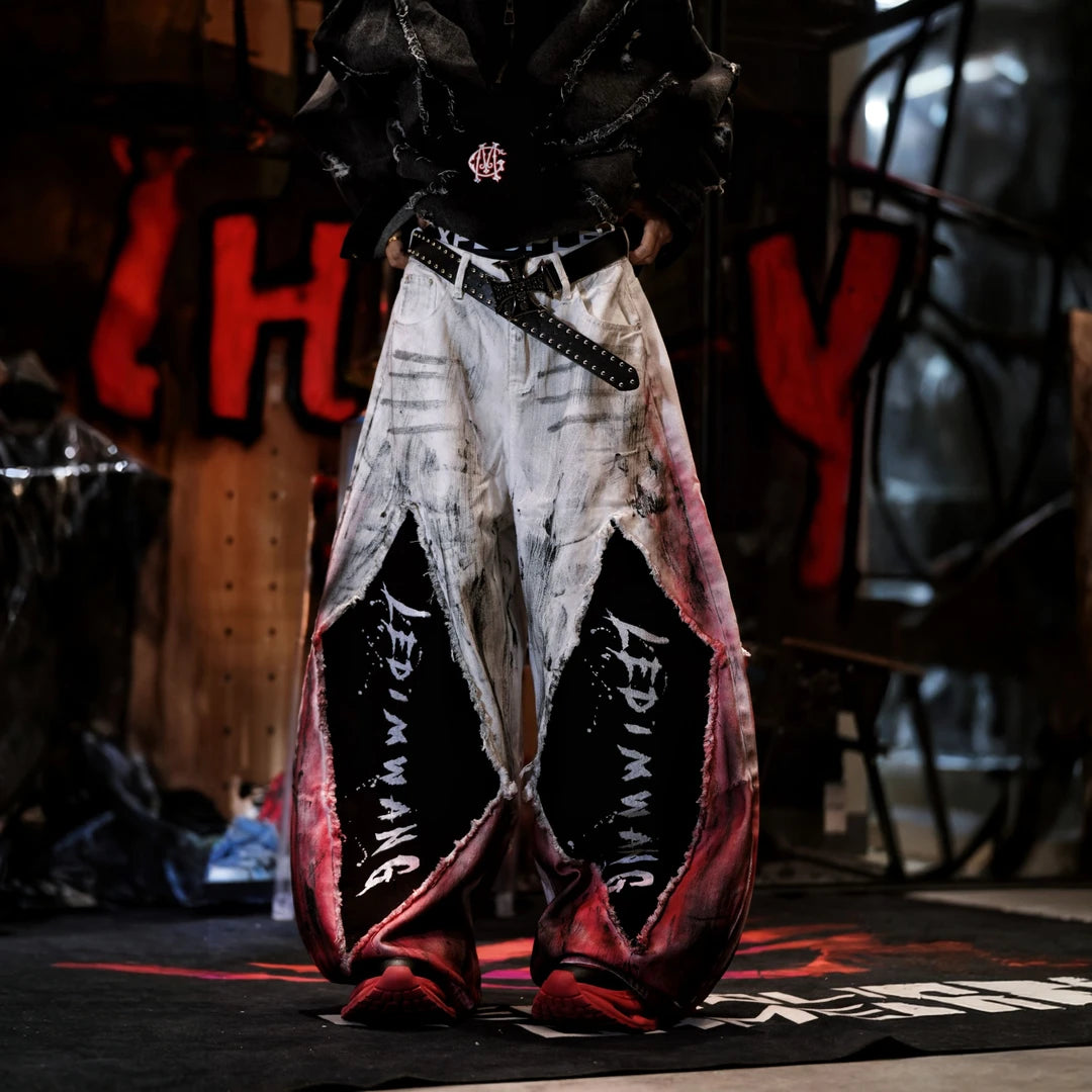 Sanhoostudio denim pants featuring a layered design, vintage washed treatment, distressed detailing, and asymmetric patchwork construction. Designed for statement streetwear styling with rugged denim texture, unconventional panel structure, relaxed proportions, and distinctive everyday urban appeal.
