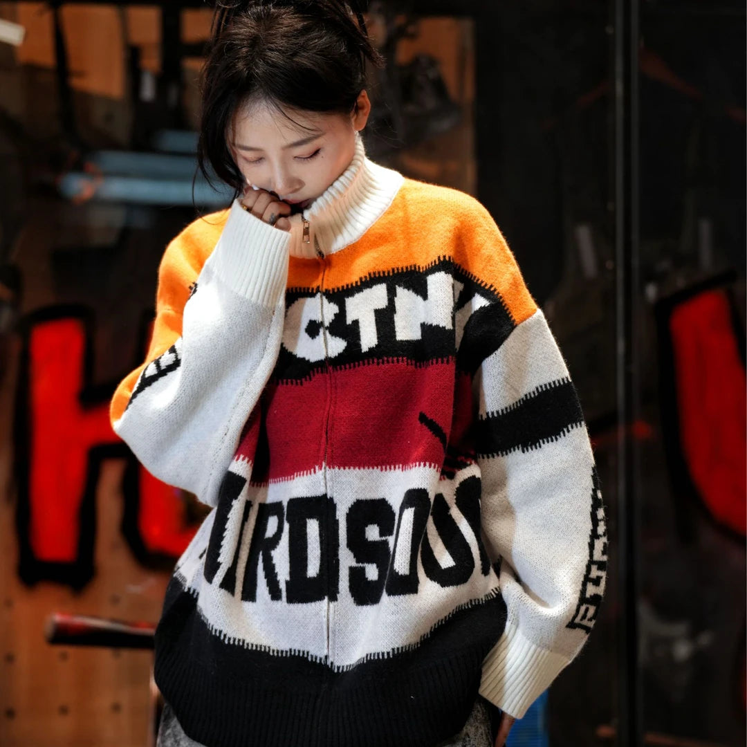 Sanhoostudio knit sweater featuring Suzuki-inspired colorblock detailing, heavyweight knitted construction, distressed graffiti artwork, and hand-painted patchwork elements. Designed with a relaxed oversized silhouette for statement streetwear styling, distinctive racing-inspired aesthetics, comfortable warmth, and bol
