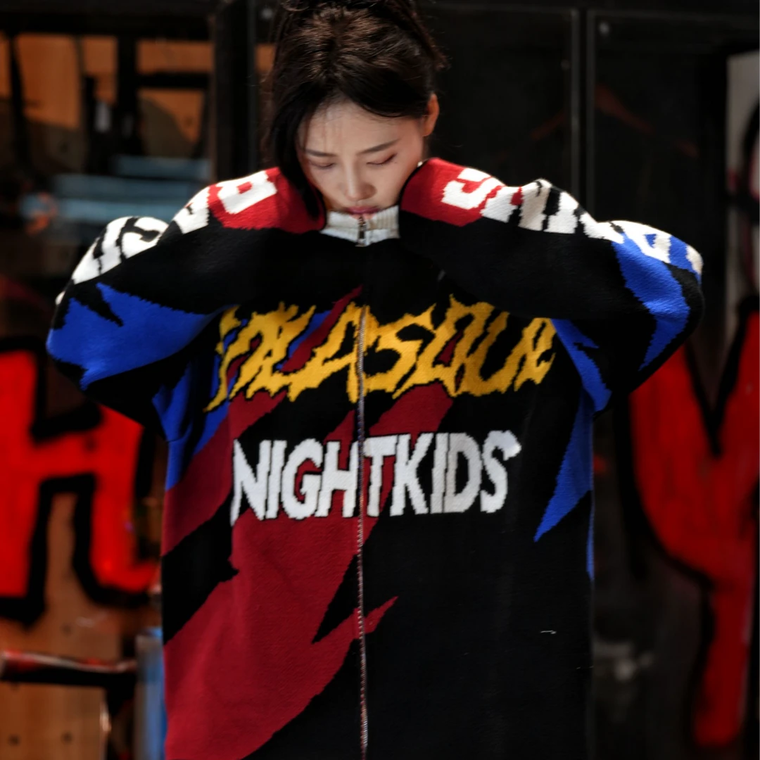 Sanhoostudio knit sweater featuring thunder-inspired contrasting colors, heavyweight knitted construction, distressed graffiti artwork, and hand-painted patchwork detailing. Designed for statement streetwear styling with a relaxed oversized silhouette, bold color combinations, comfortable warmth, and distinctive appeal