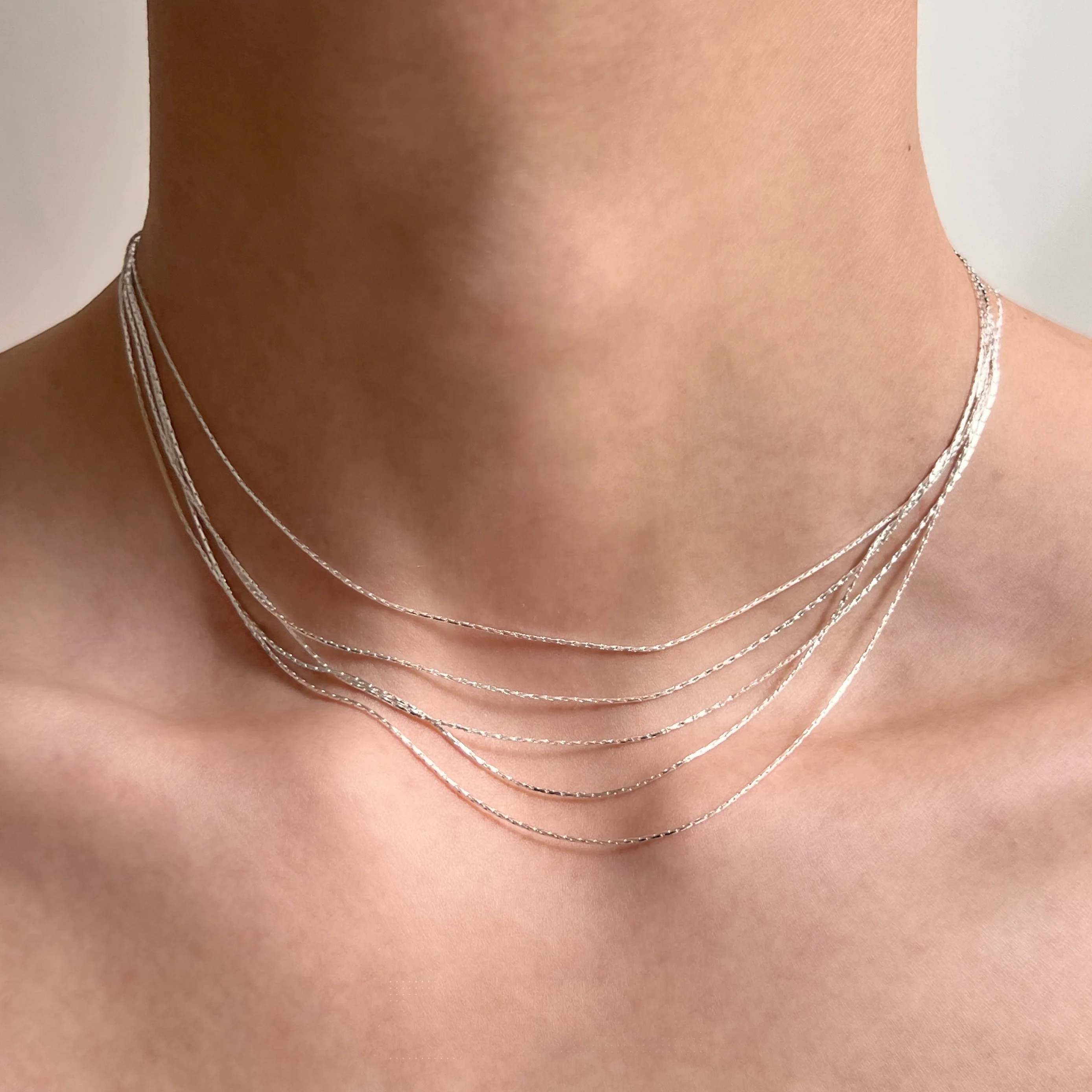Sanhoostudio’s silver multi-layer thin chain necklace delivers delicate sparkle and romantic bling—perfect for layering, special occasions, and elevating everyday outfits with refined shine.