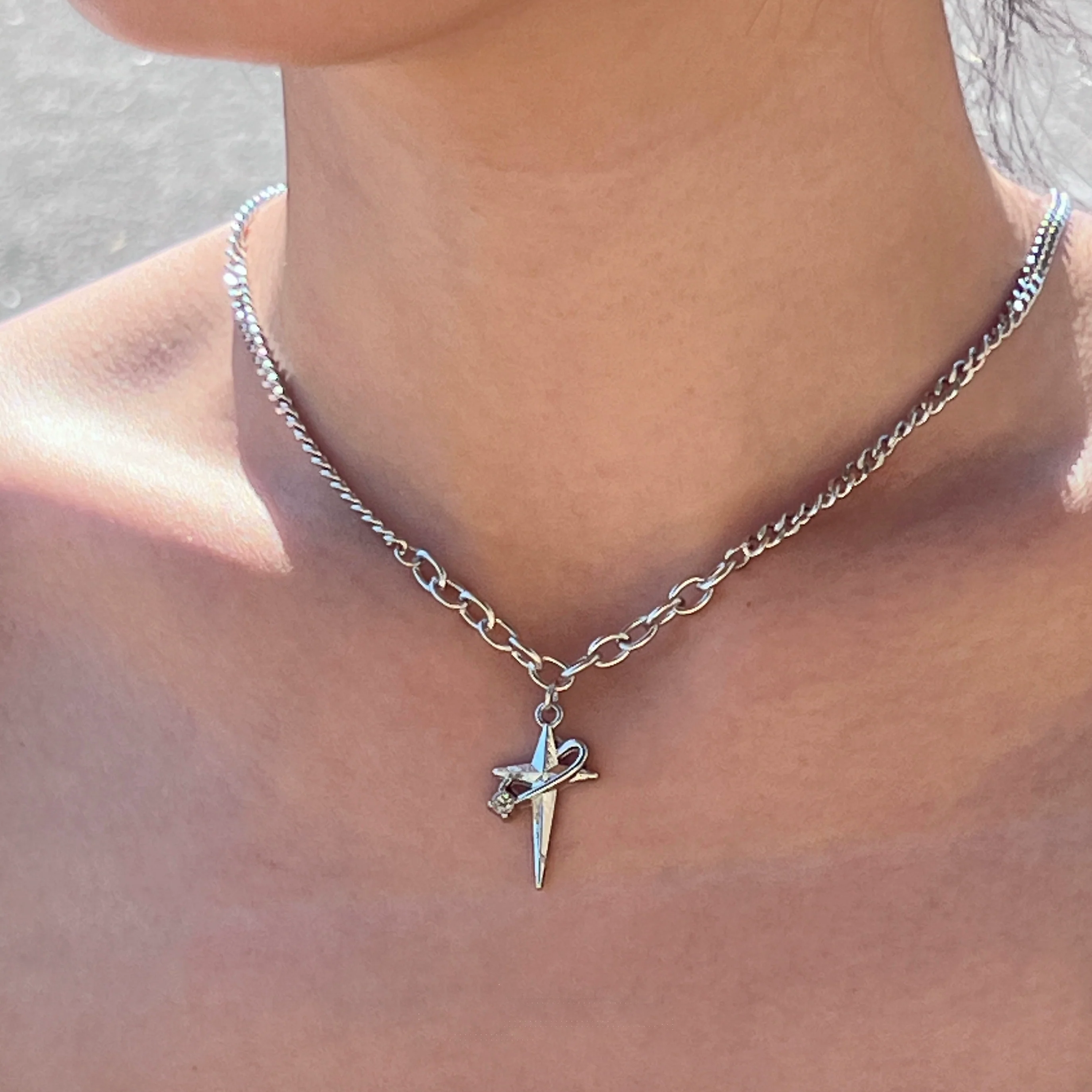 Sanhoostudio’s star cross wrap titanium necklace wraps gothic motifs into layered titanium design—sturdy, stylish, and ideal for dark-luxe streetwear and layered accessorizing.