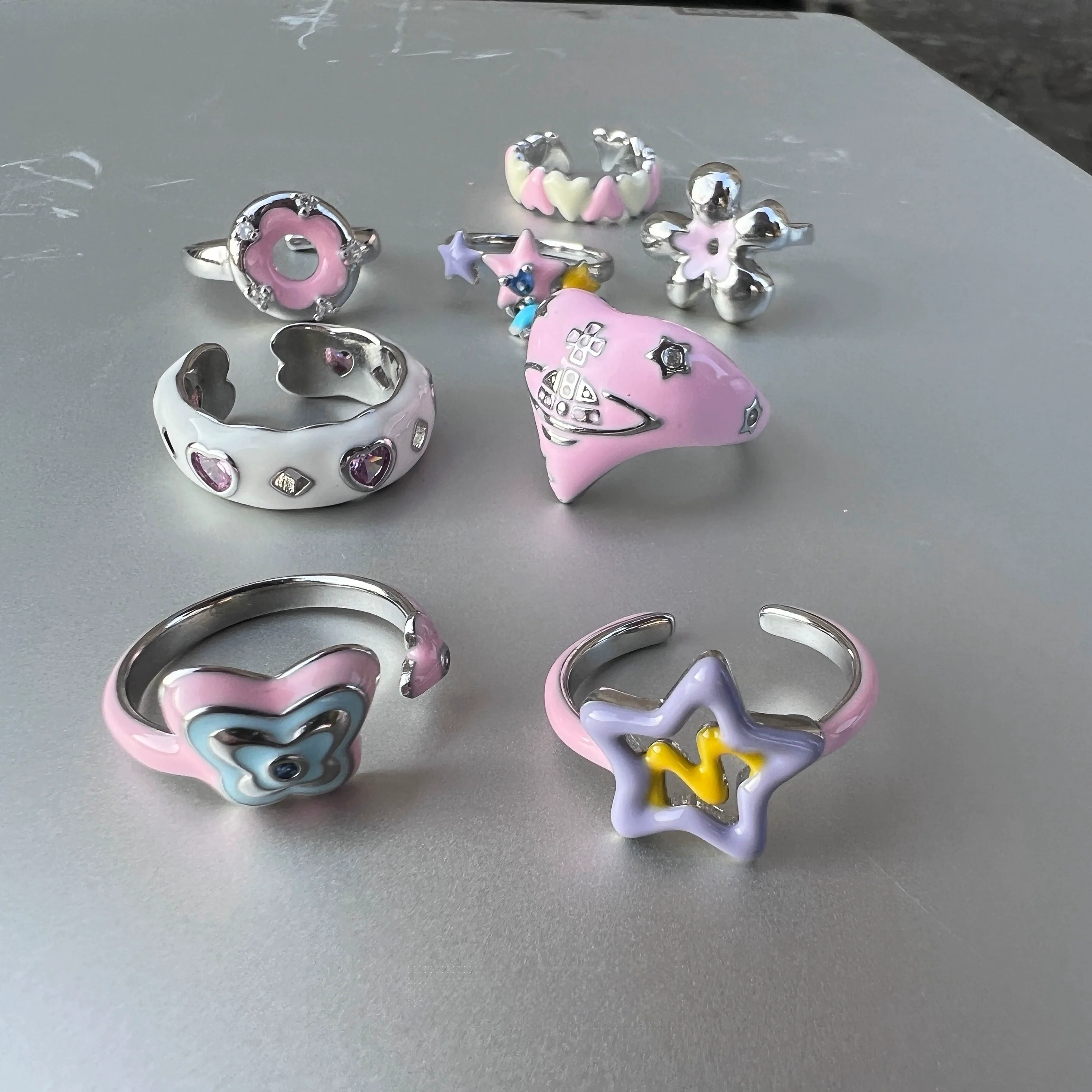 Add color with Sanhoostudio’s graffiti dopamine ring—vibrant hues and playful design bring Barbiecore energy to streetwear. A fun statement ring for bold styling and daily looks.