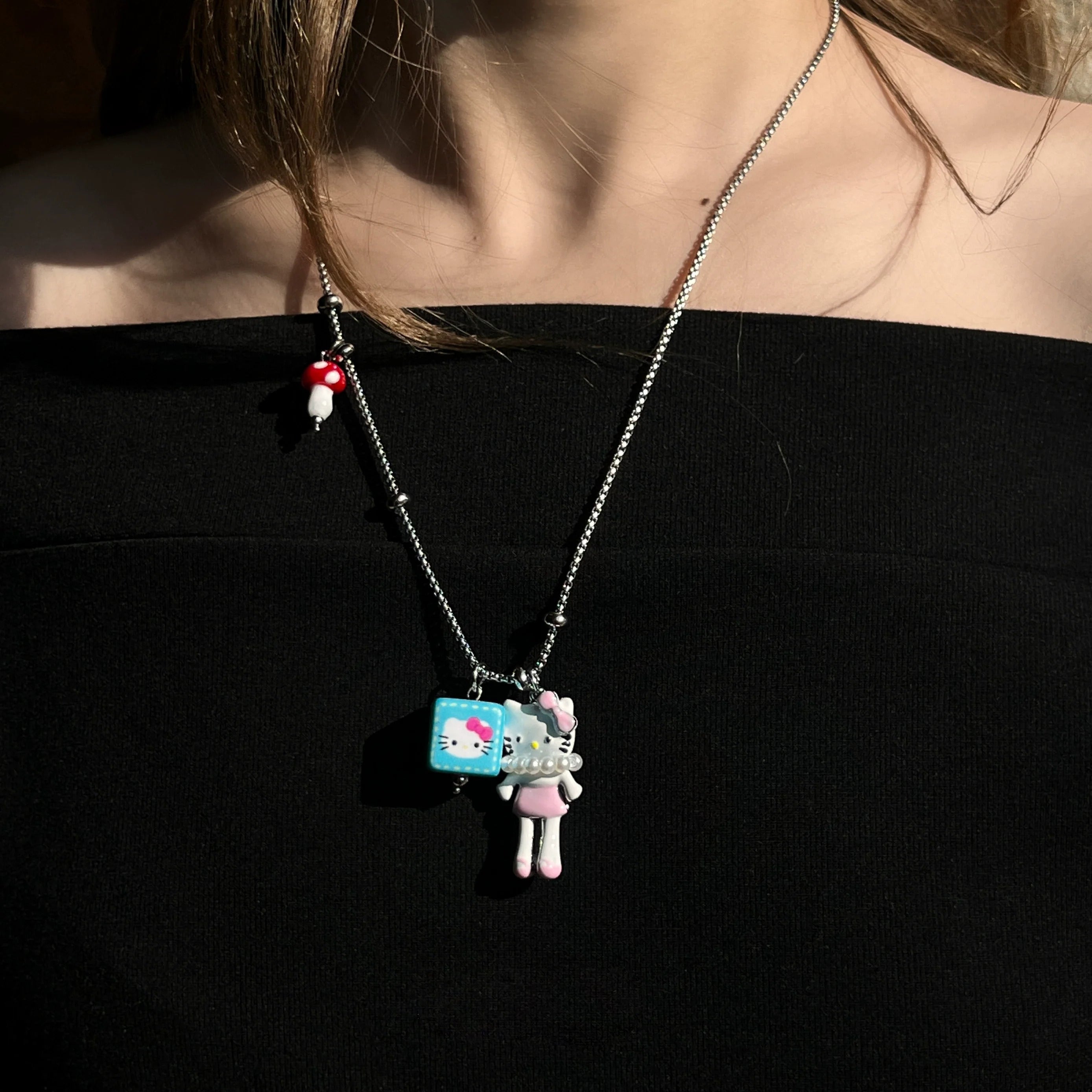 Sanhoostudio’s cute KT cat cartoon necklace adds a fun, youthful touch to any outfit. Designed for playful streetwear and kawaii-inspired fashion, it’s perfect for bold and quirky style statements.