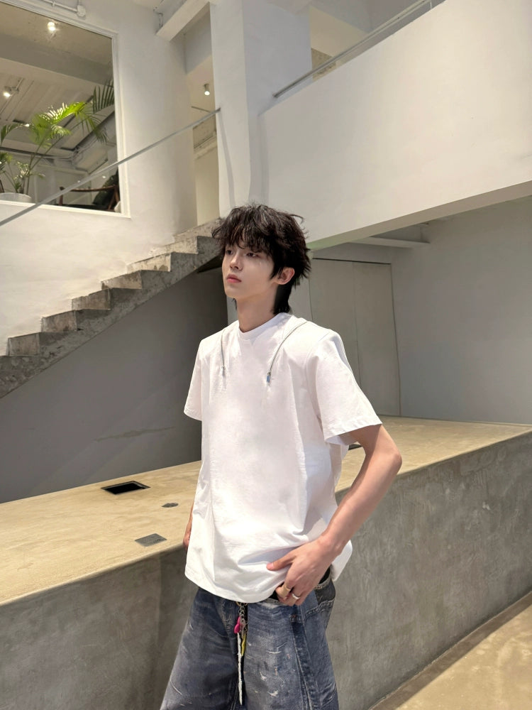 Designed by Sanhoostudio, this T-shirt features spine-inspired metallic pleats paired with structured shoulder pads for a futuristic silhouette. Its innovative design and premium construction highlight an avant-garde streetwear vibe, balancing comfort with standout style for bold everyday looks.