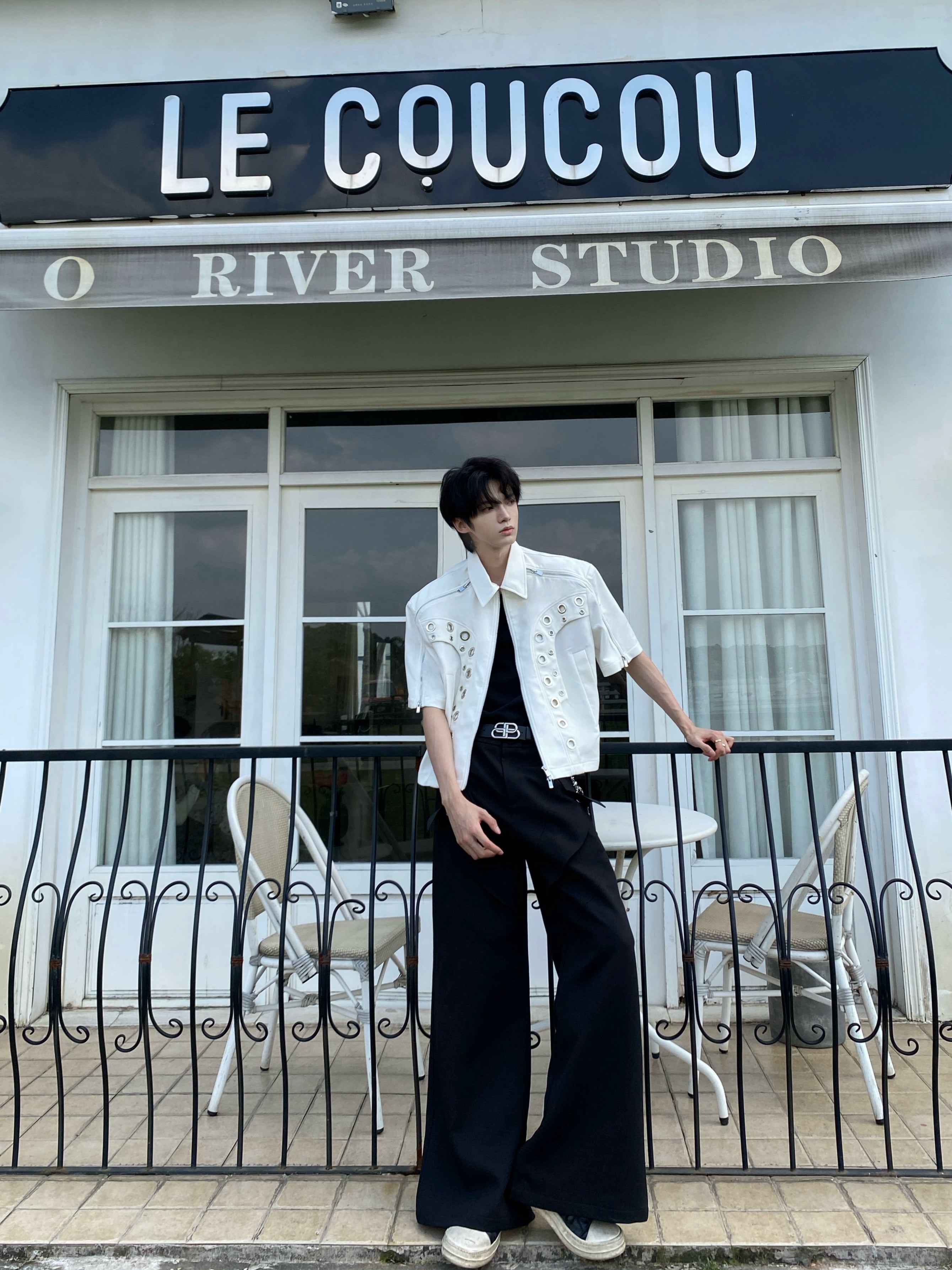 This avant-garde cropped jacket by Sanhoostudio showcases futuristic hollow-metal inspired cutouts with bold shoulder pads. Its oversized silhouette, lightweight material, and modern edge make it a standout layering piece for streetwear fans who embrace unique design and cutting-edge style.