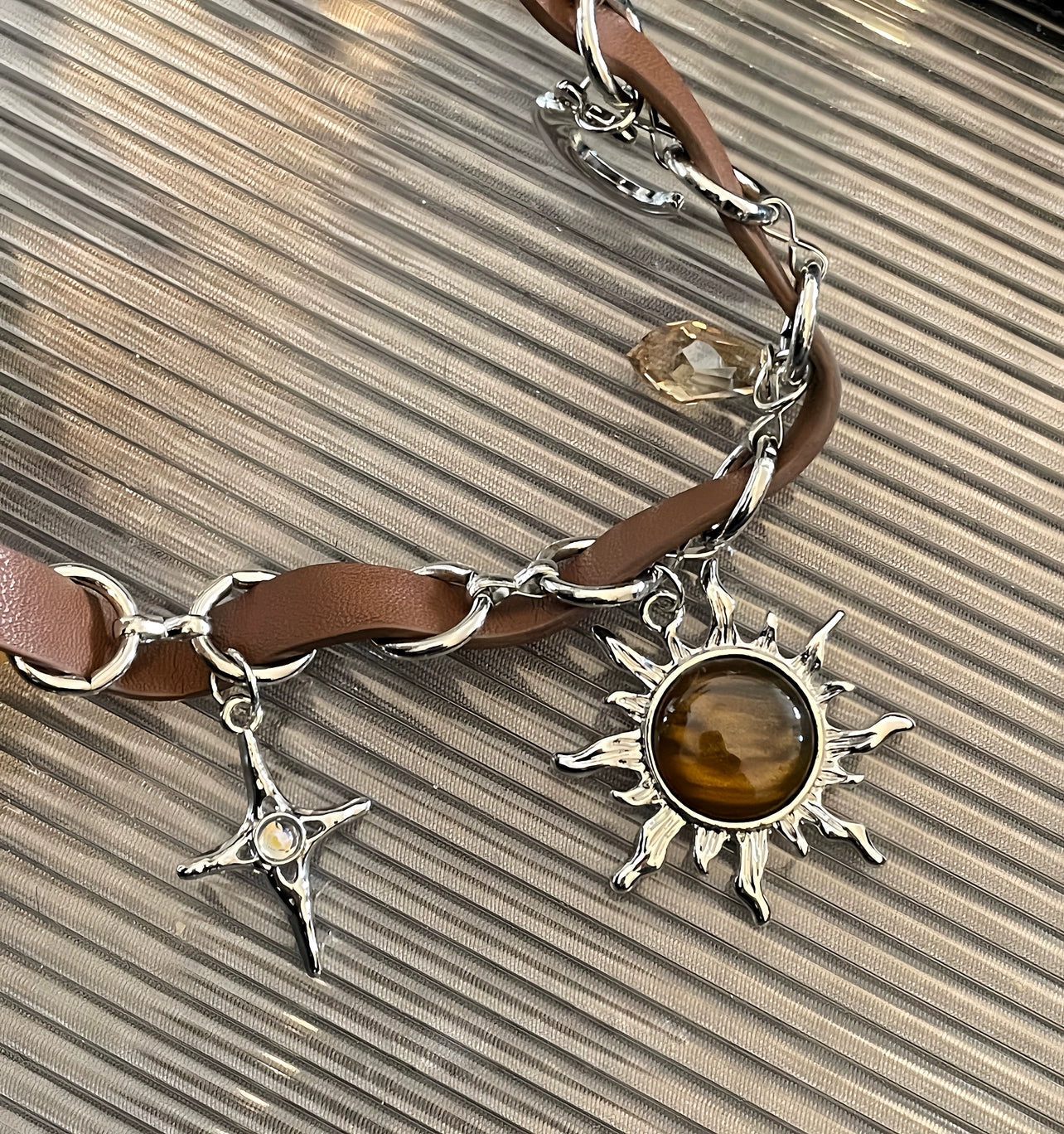 Sanhoostudio’s Mallard brown sunburst choker necklace showcases a bold sun-inspired design with warm brown tones, perfect for fashion-forward individuals seeking a standout, retro-luxe accessory.
