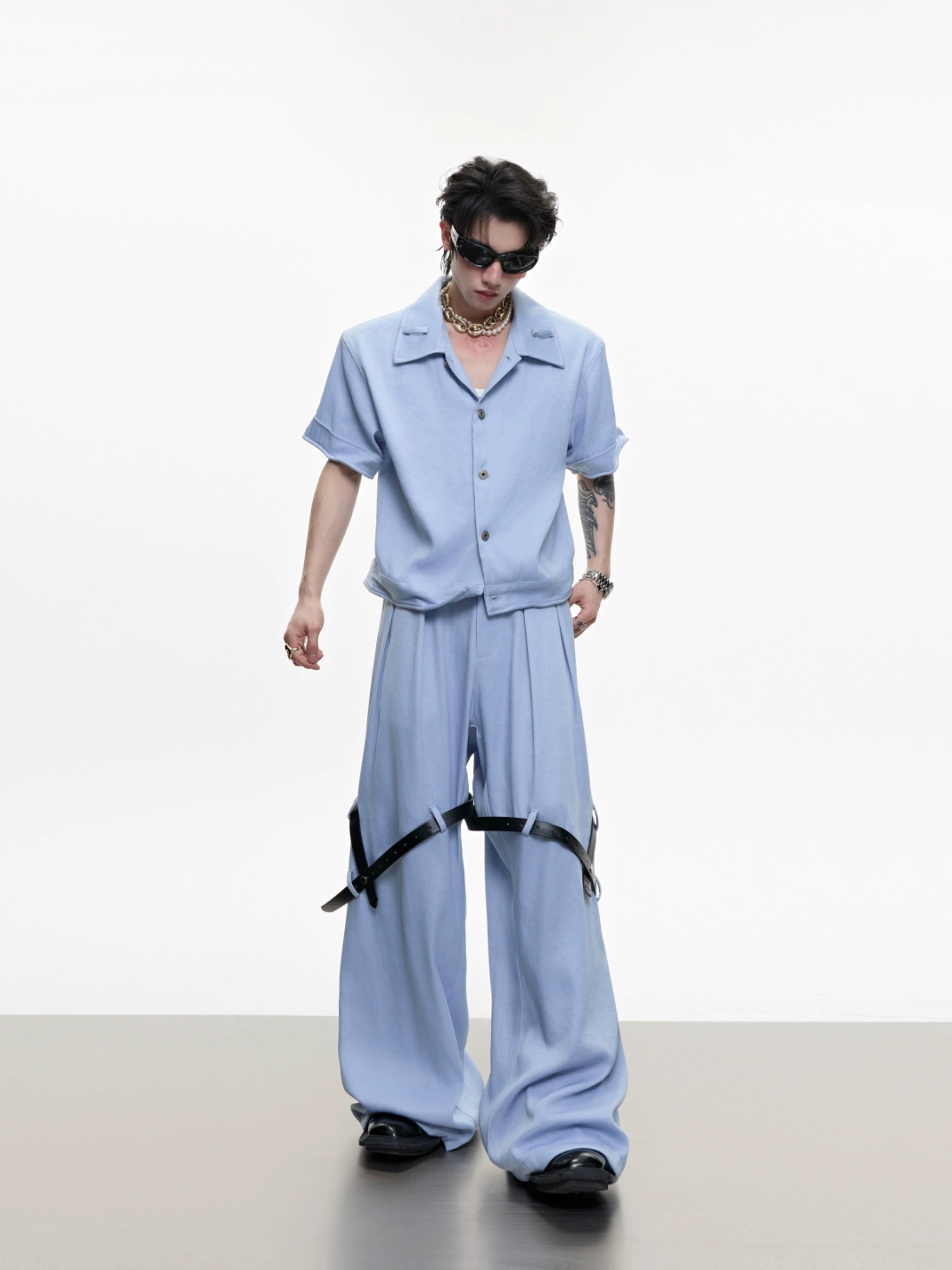 The Sanhoostudio twill textured pants showcase structured tailoring with unique belt-inspired patchwork. Combining minimalism with avant-garde detailing, they bring an elevated urban aesthetic to both casual and semi-formal styling.