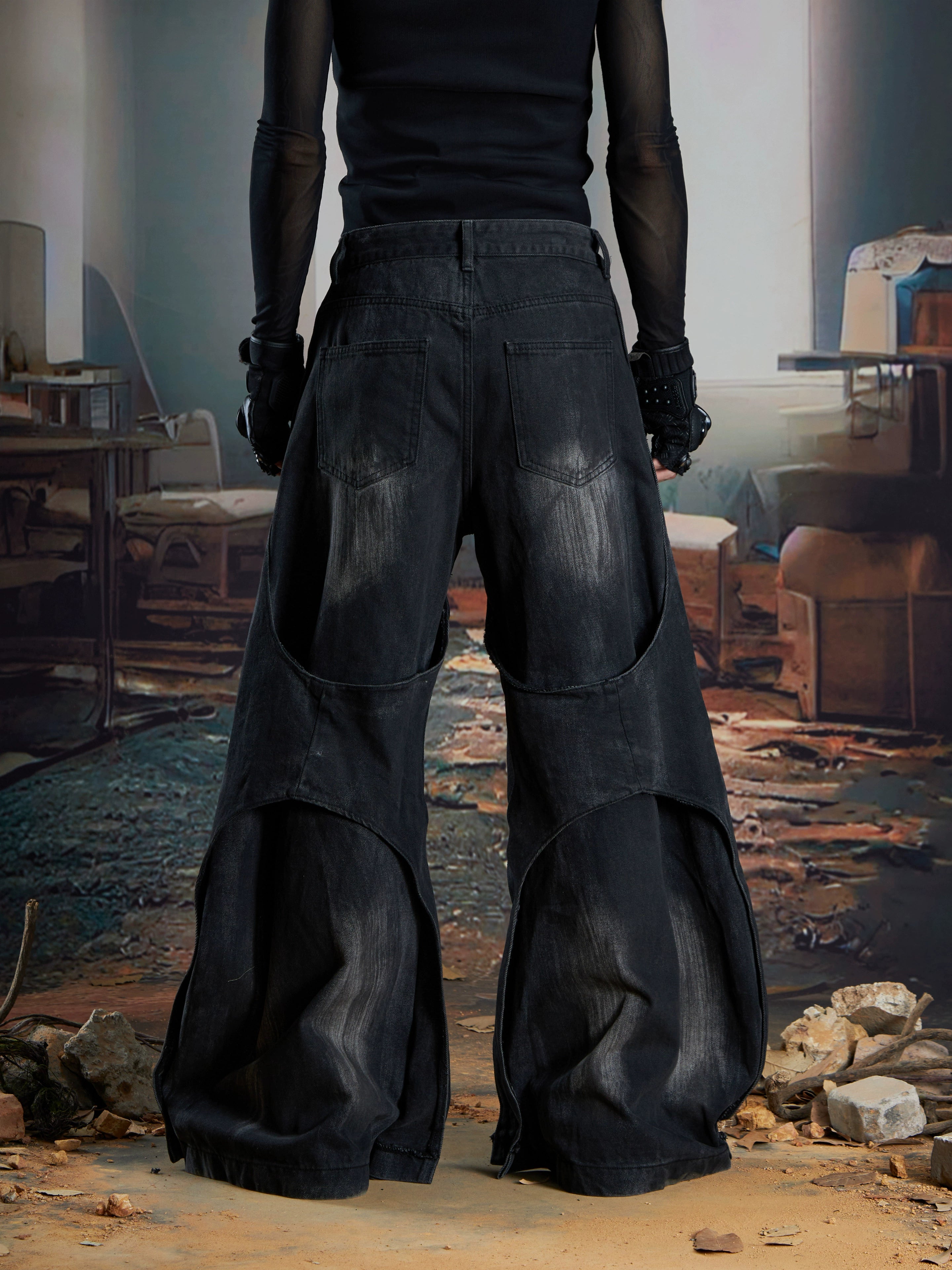 Dual-layer spliced jeans with frayed tassels, washed fading, and wide-leg construction. Sanhoostudio’s dark heavy-duty street aesthetic.