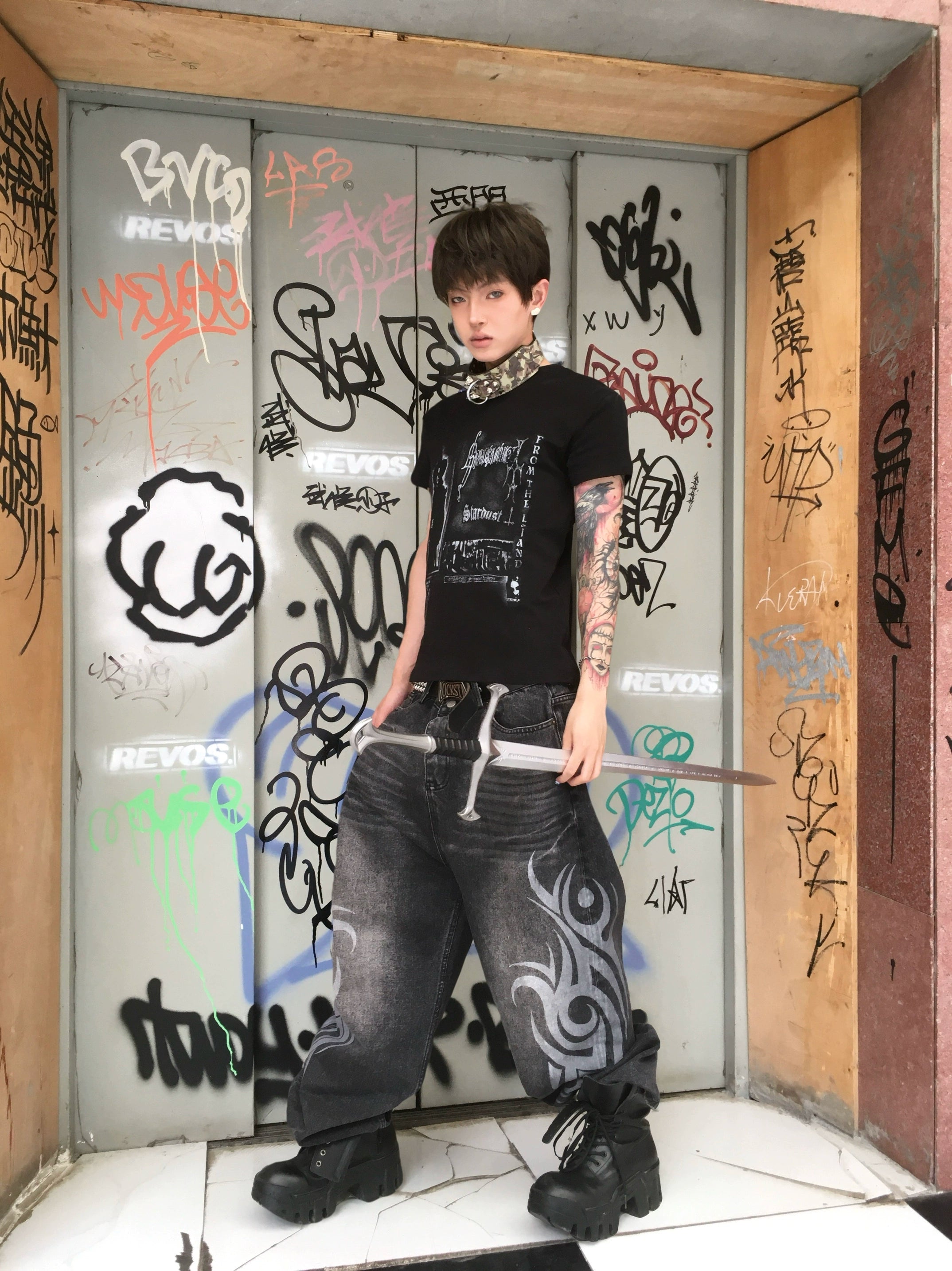 These Sanhoostudio jeans showcase bold totem rune prints across a wide-leg straight cut. The oversized fit and retro wash add cultural inspiration to streetwear, making them a unique fashion-forward piece.
