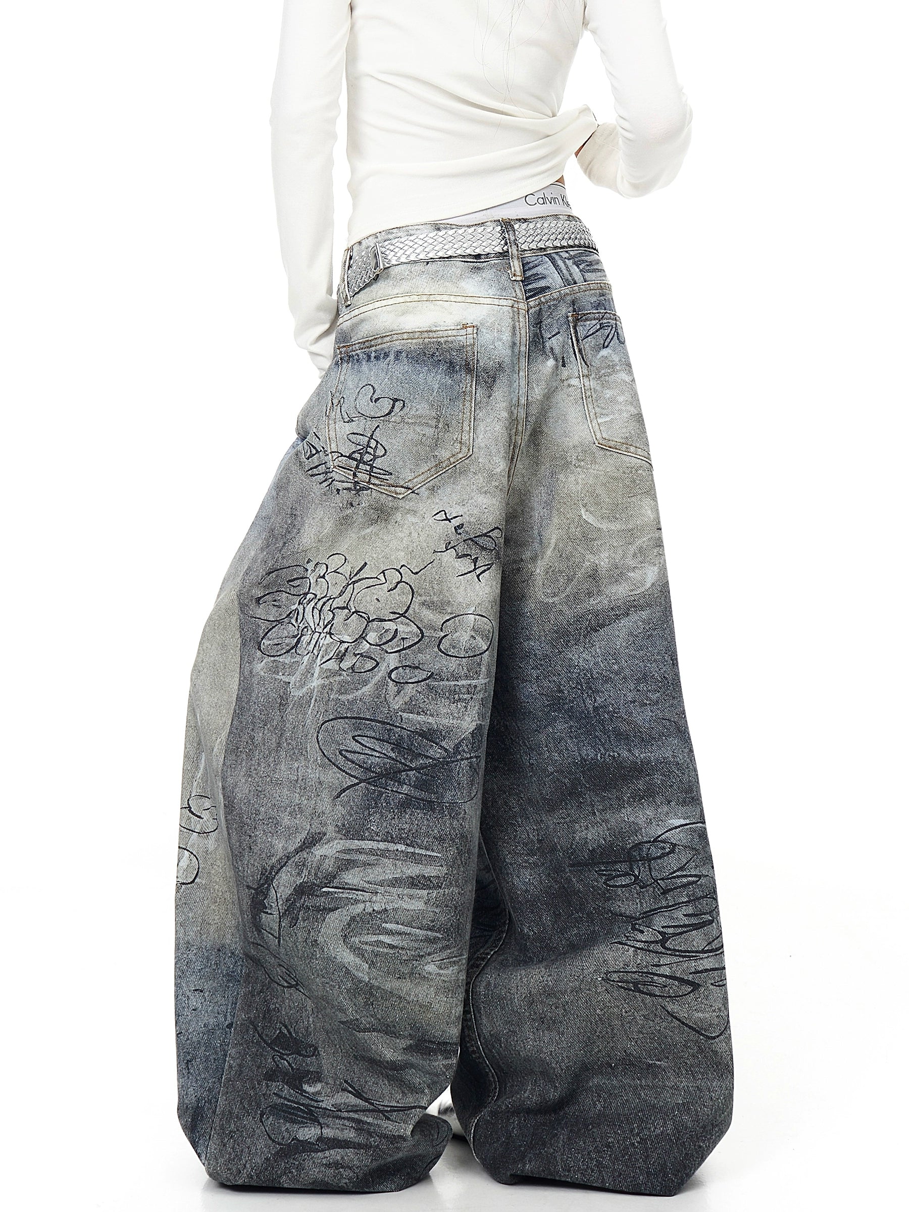 Crafted with graffiti-inspired wash and distressed texture, these Sanhoostudio denim pants bring American vintage energy and street-style confidence to life.