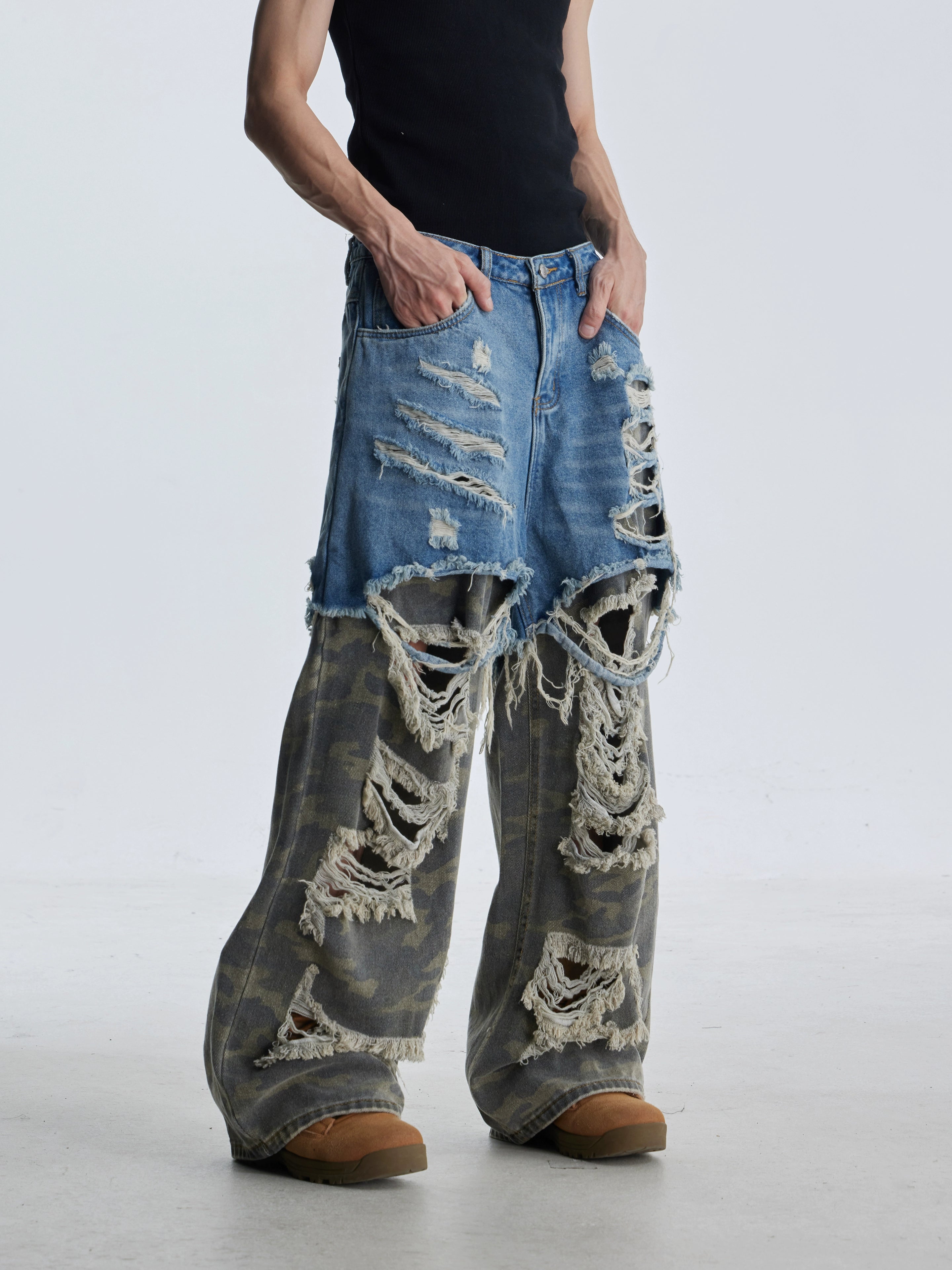 These deconstructed patchwork camo jeans from Sanhoostudio feature a unique layered fake two-piece effect, distressed ripped accents, and a loose straight-leg silhouette. Combining vintage inspiration with edgy high street aesthetics, they are perfect for streetwear lovers seeking comfort, individuality.