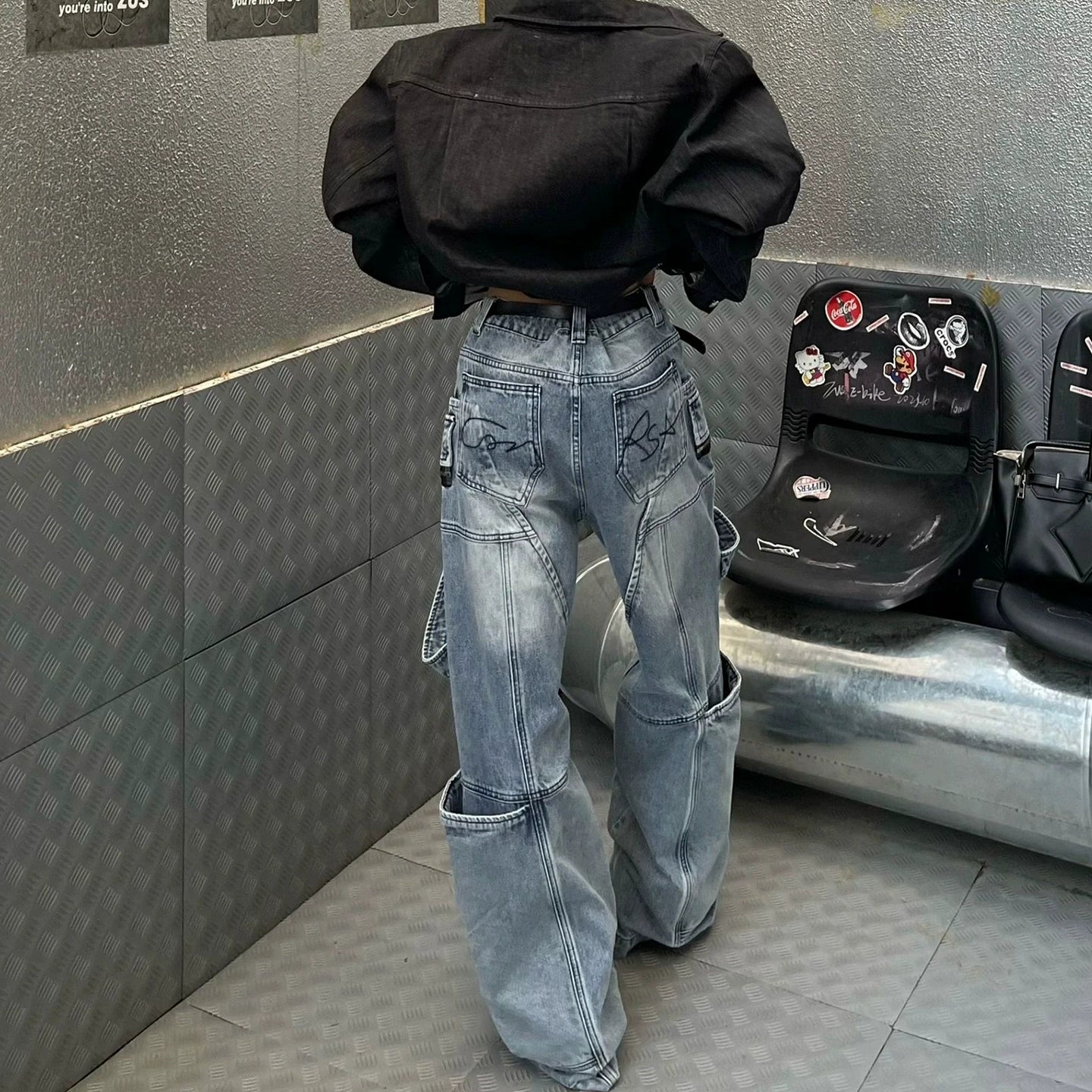 These heavy-duty cargo pants from Sanhoostudio combine deconstructed patchwork with multi-pocket functionality, delivering rugged streetwear style in a wide-leg floor-length cut. A bold fashion-forward piece.