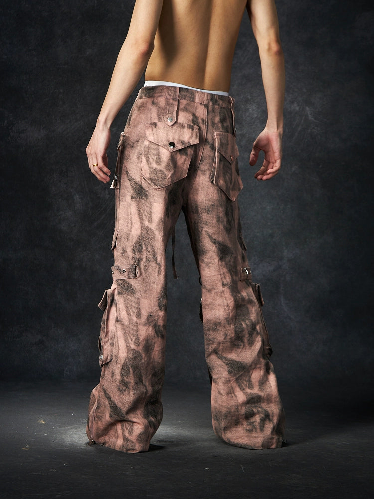The Sanhoostudio distressed mud-dye cargo pants feature a heavy washed finish, rugged multi-pocket design, and a relaxed straight-leg fit. Perfect for utilitarian and high street styling, they combine functionality with bold design, making them an essential statement for everyday streetwear wardrobes.