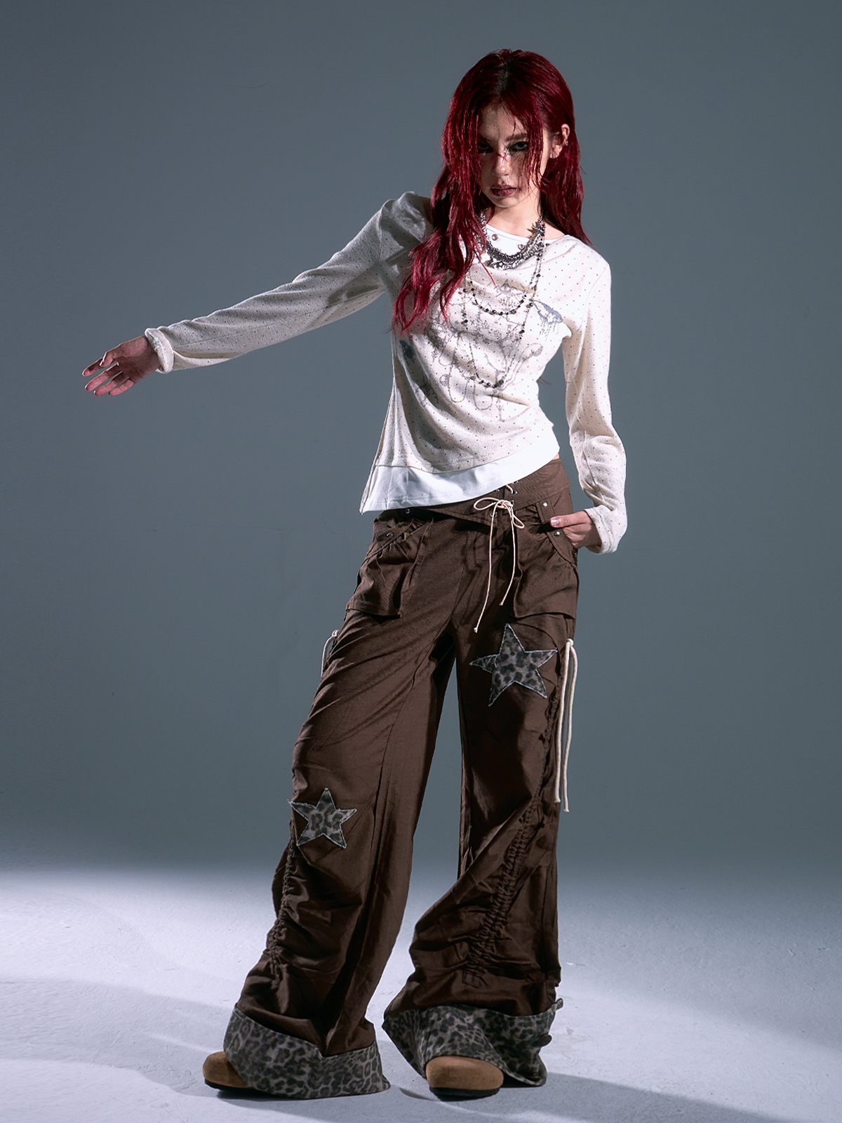 Shop Sanhoostudio’s retro-inspired polka dot knit top with a layered effect and slim fit. A perfect mix of vintage elegance and modern streetwear for versatile styling.