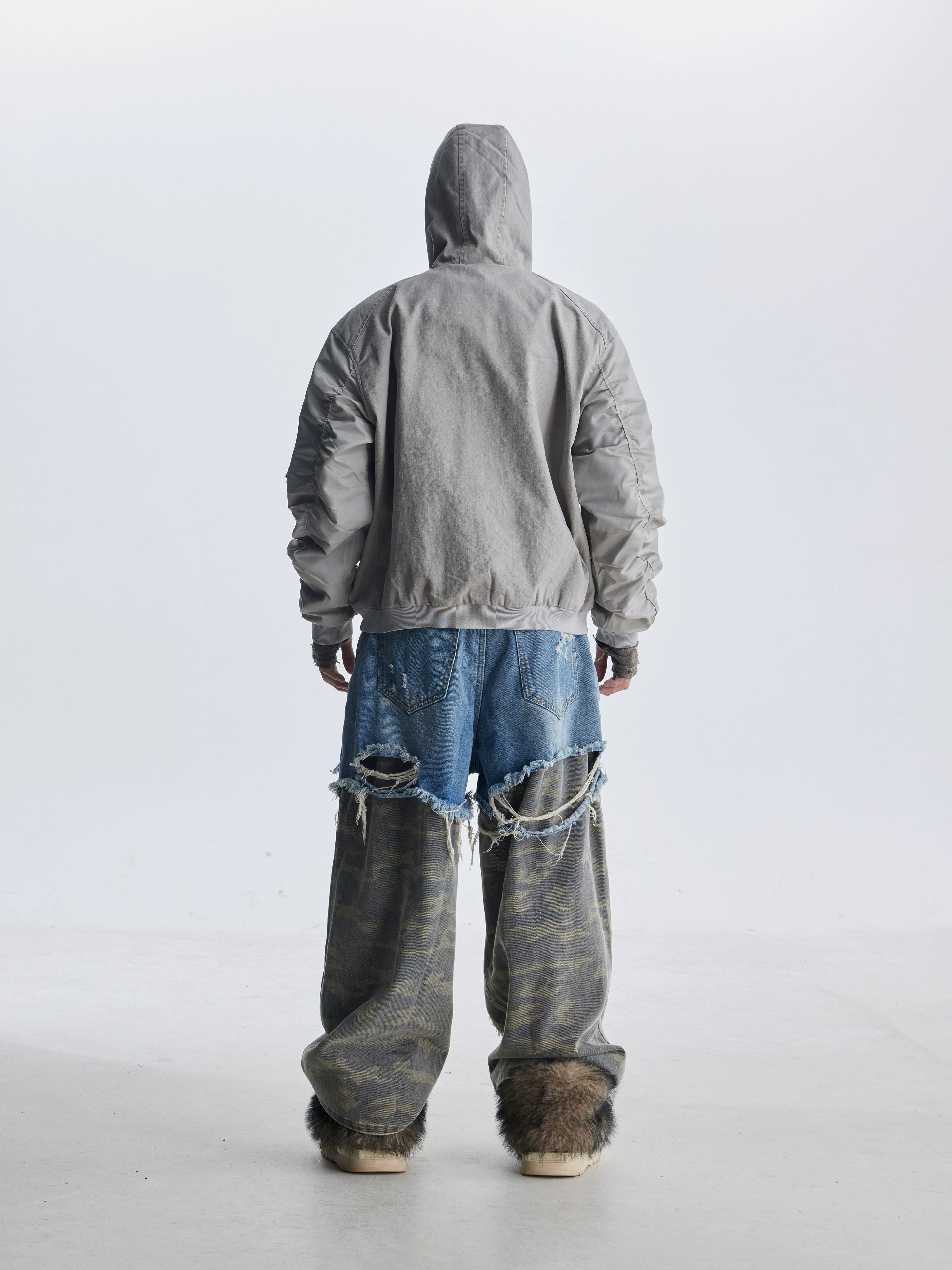 These deconstructed patchwork camo jeans from Sanhoostudio feature a unique layered fake two-piece effect, distressed ripped accents, and a loose straight-leg silhouette. Combining vintage inspiration with edgy high street aesthetics, they are perfect for streetwear lovers seeking comfort, individuality.