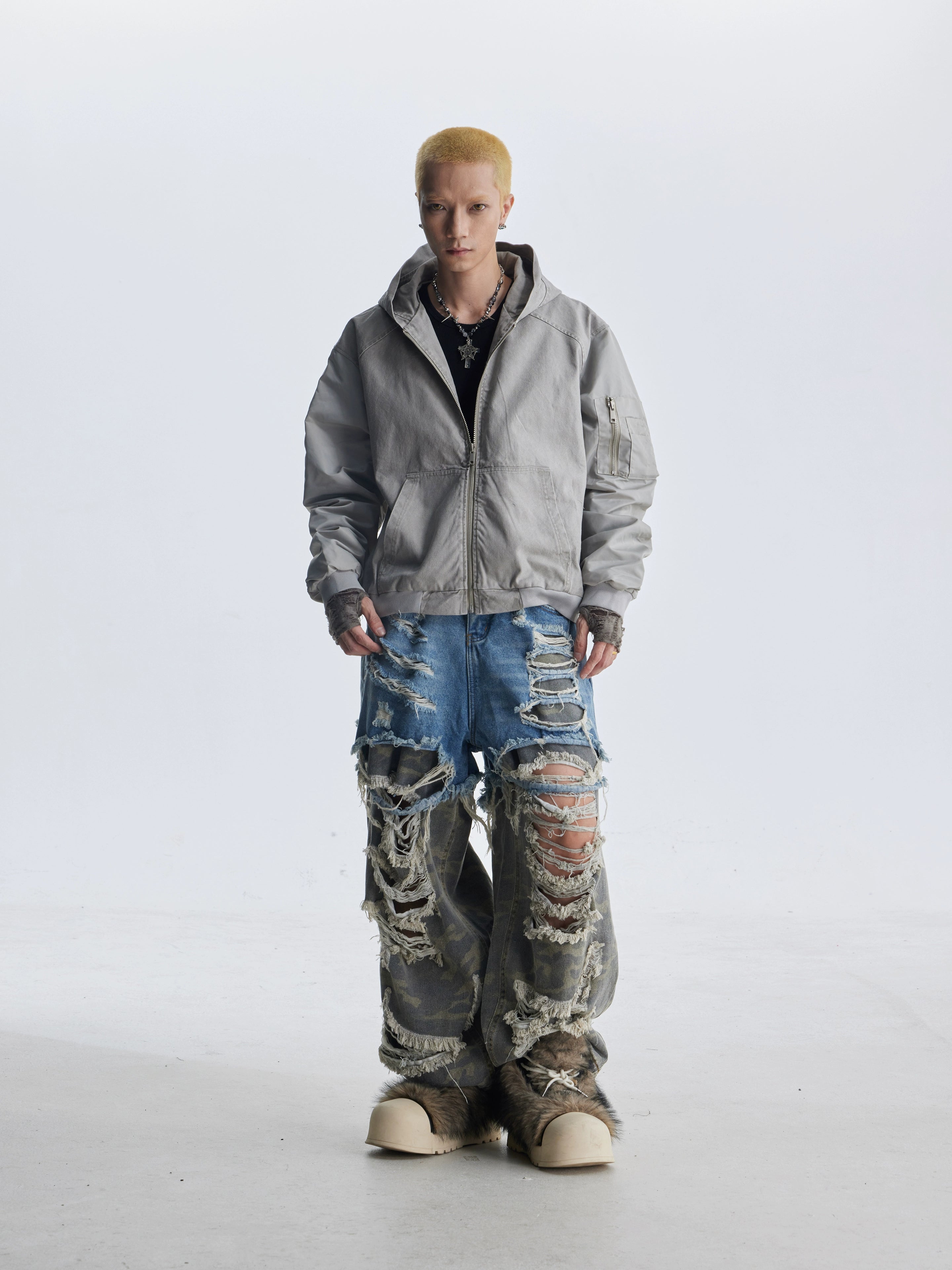 These deconstructed patchwork camo jeans from Sanhoostudio feature a unique layered fake two-piece effect, distressed ripped accents, and a loose straight-leg silhouette. Combining vintage inspiration with edgy high street aesthetics, they are perfect for streetwear lovers seeking comfort, individuality.
