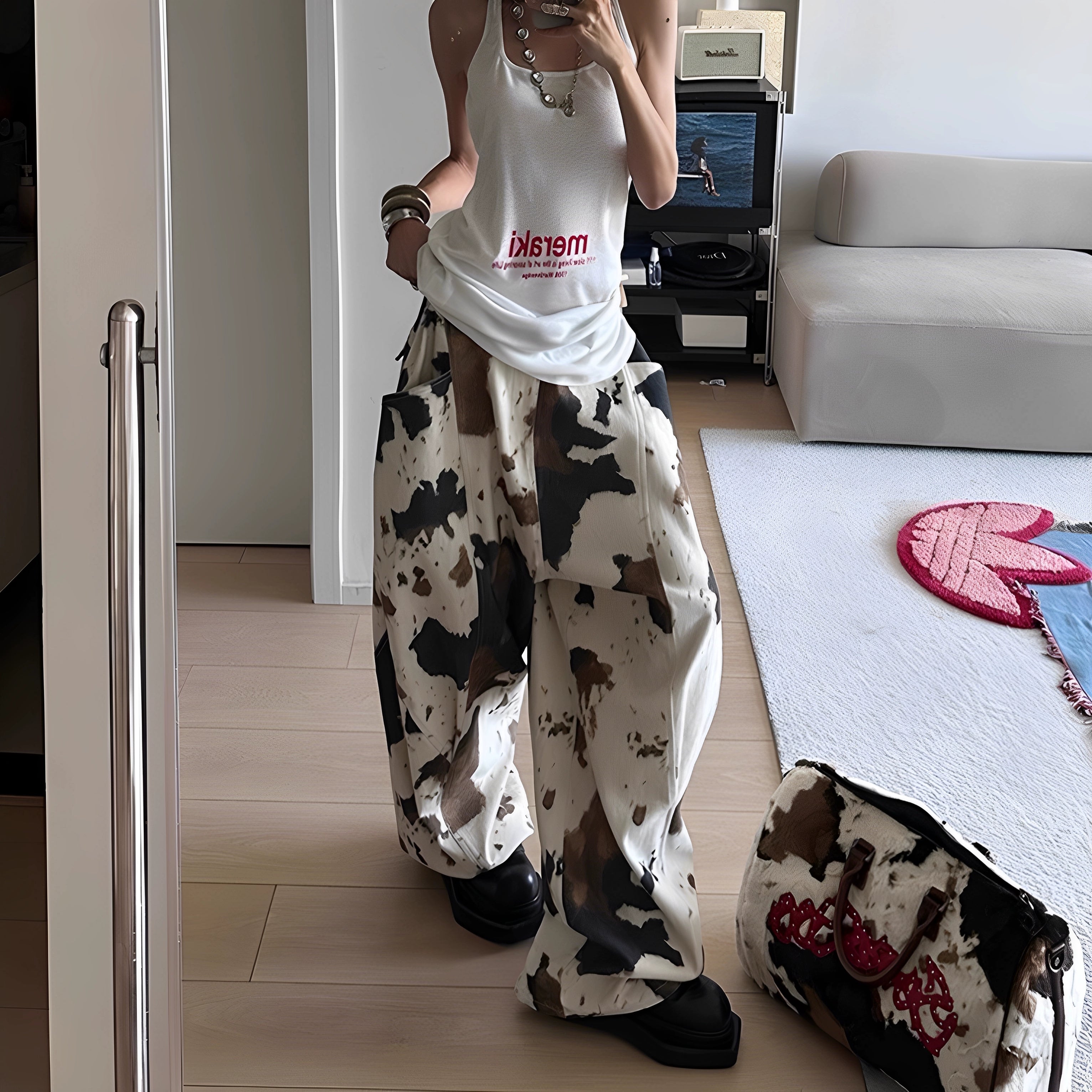 The Sanhoostudio cow print jeans feature a soft apricot colorway with wide-leg design and vintage wash. Playful yet versatile, they fuse retro charm with modern high street fashion.