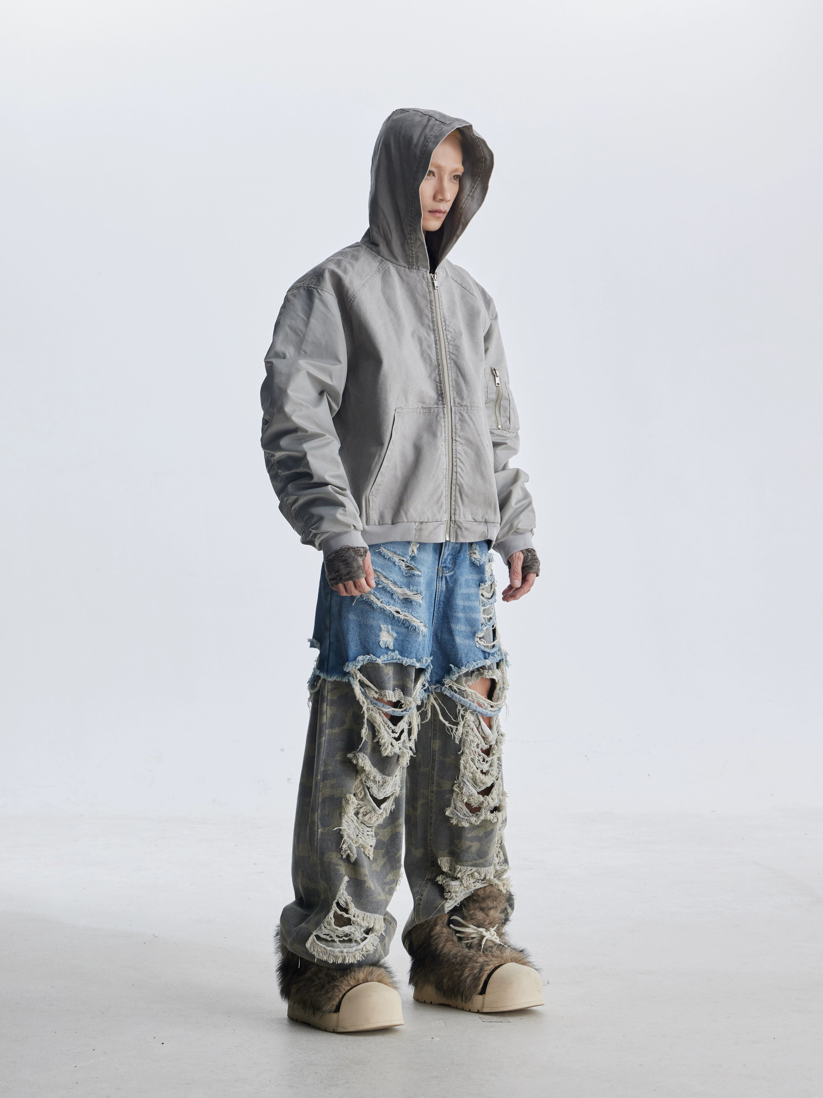 These deconstructed patchwork camo jeans from Sanhoostudio feature a unique layered fake two-piece effect, distressed ripped accents, and a loose straight-leg silhouette. Combining vintage inspiration with edgy high street aesthetics, they are perfect for streetwear lovers seeking comfort, individuality.
