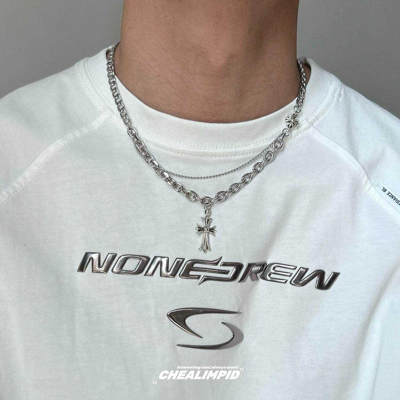 Discover Sanhoostudio’s cross double-layer titanium necklace—sturdy titanium construction paired with layered chains for a versatile unisex accessory suitable for casual and dressy street looks.