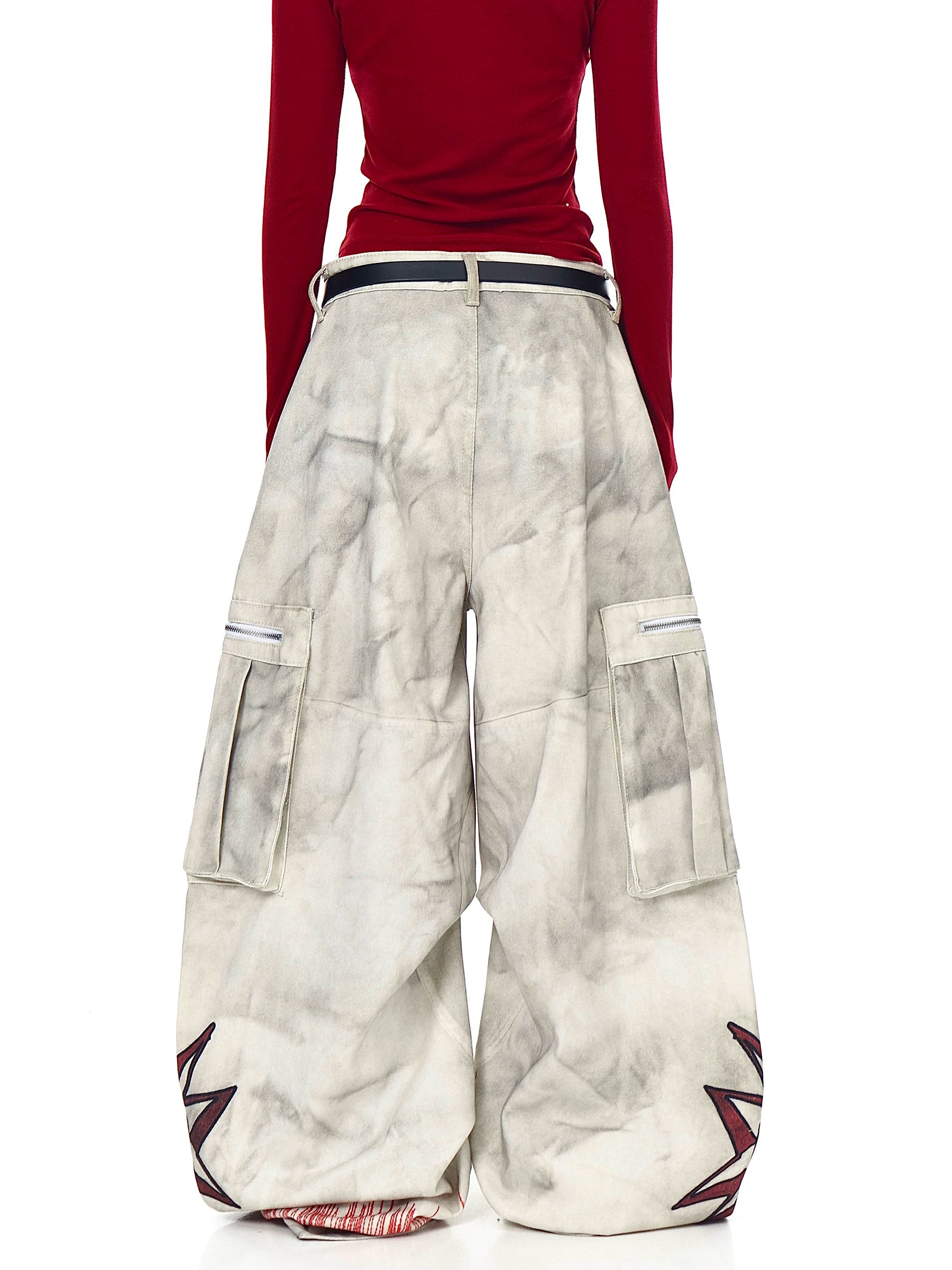 Sanhoostudio wide leg denim pants featuring distressed wash, graffiti details, and multi-pocket workwear design. Built with pleated structure for bold streetwear styling.