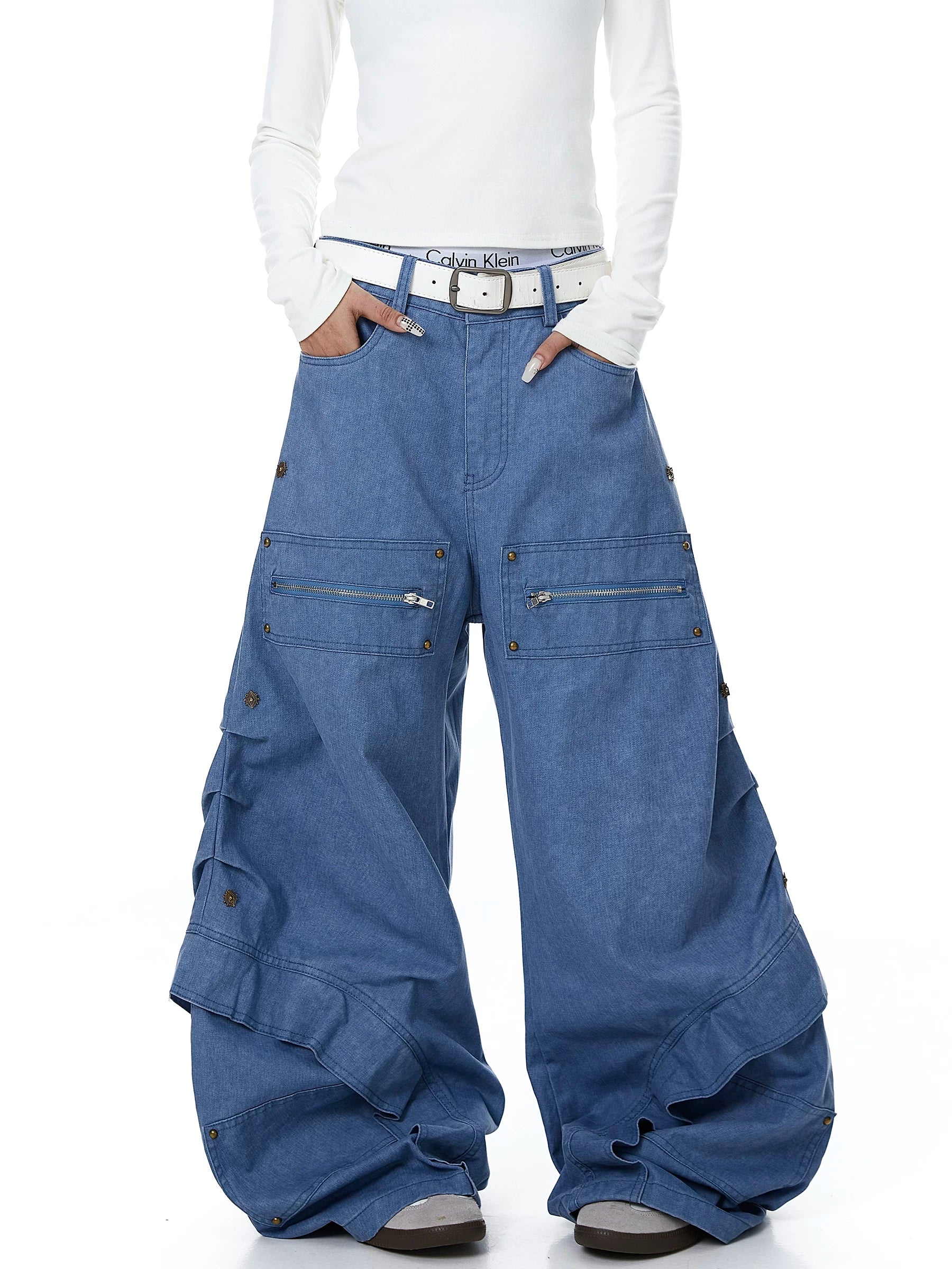 Sanhoostudio workwear denim pants featuring heavy patchwork construction and multiple utility pockets. Designed with a wide leg silhouette for modern streetwear outfits.