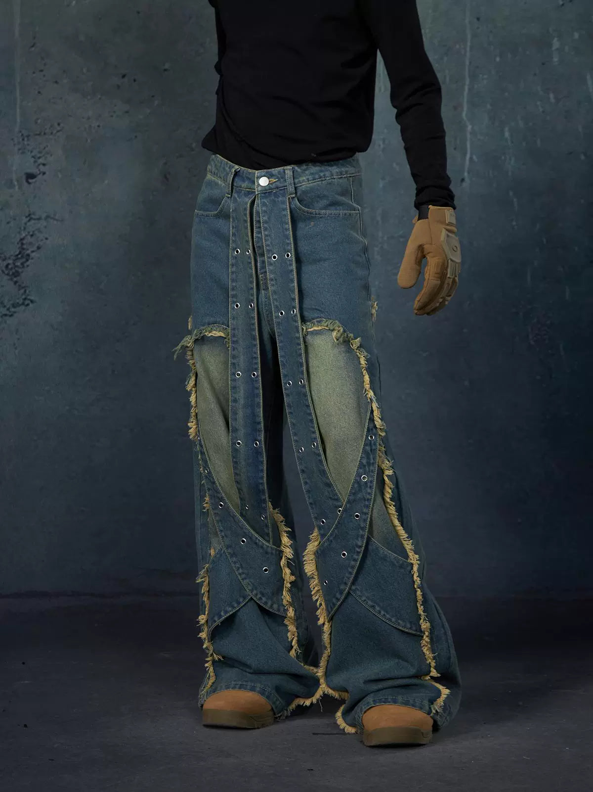 These Sanhoostudio jeans feature heavy deconstruction with strap patchwork, raw edges, and a vintage washed finish. Their oversized straight-leg silhouette adds a rugged, rebellious feel, blending avant-garde design with high street attitude.